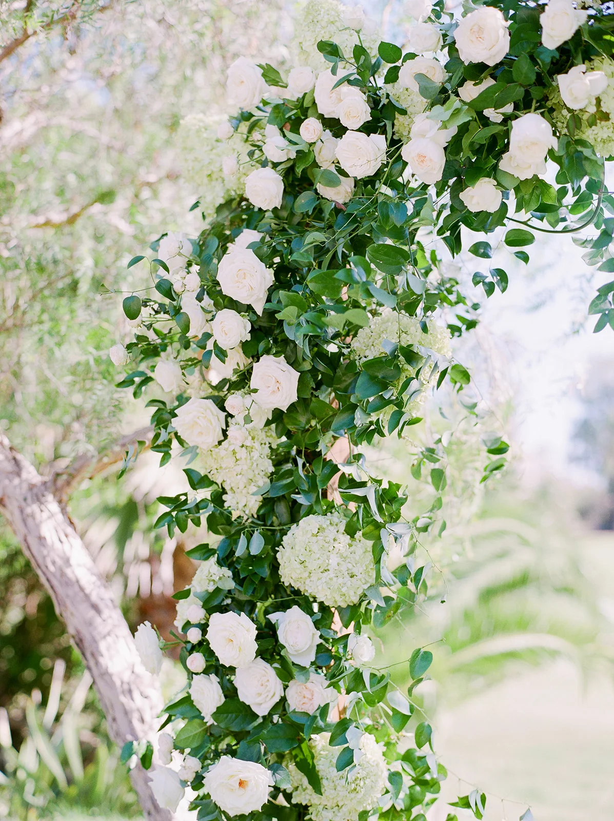 Romantic wood arch covered in greenery and flowers, outdoor ceremony | Rancho Santa Fe Golf Club | Compass Floral | Wedding Florist in San Diego and Southern California | Rachael McCall Photography