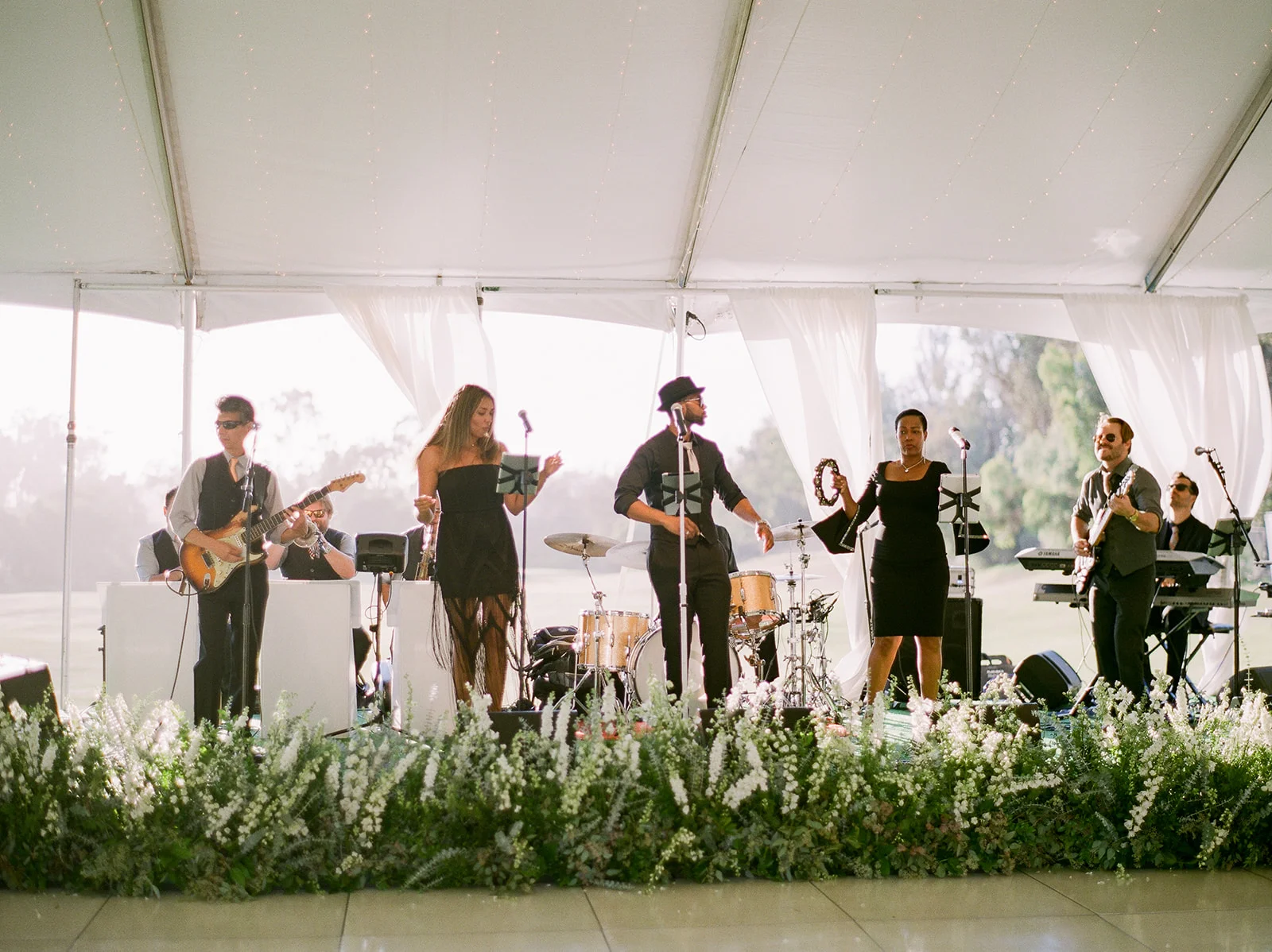 Wedding band stage covered with flowers | Rancho Santa Fe Golf Club | Compass Floral | Wedding Florist in San Diego and Southern California | Rachael McCall Photography