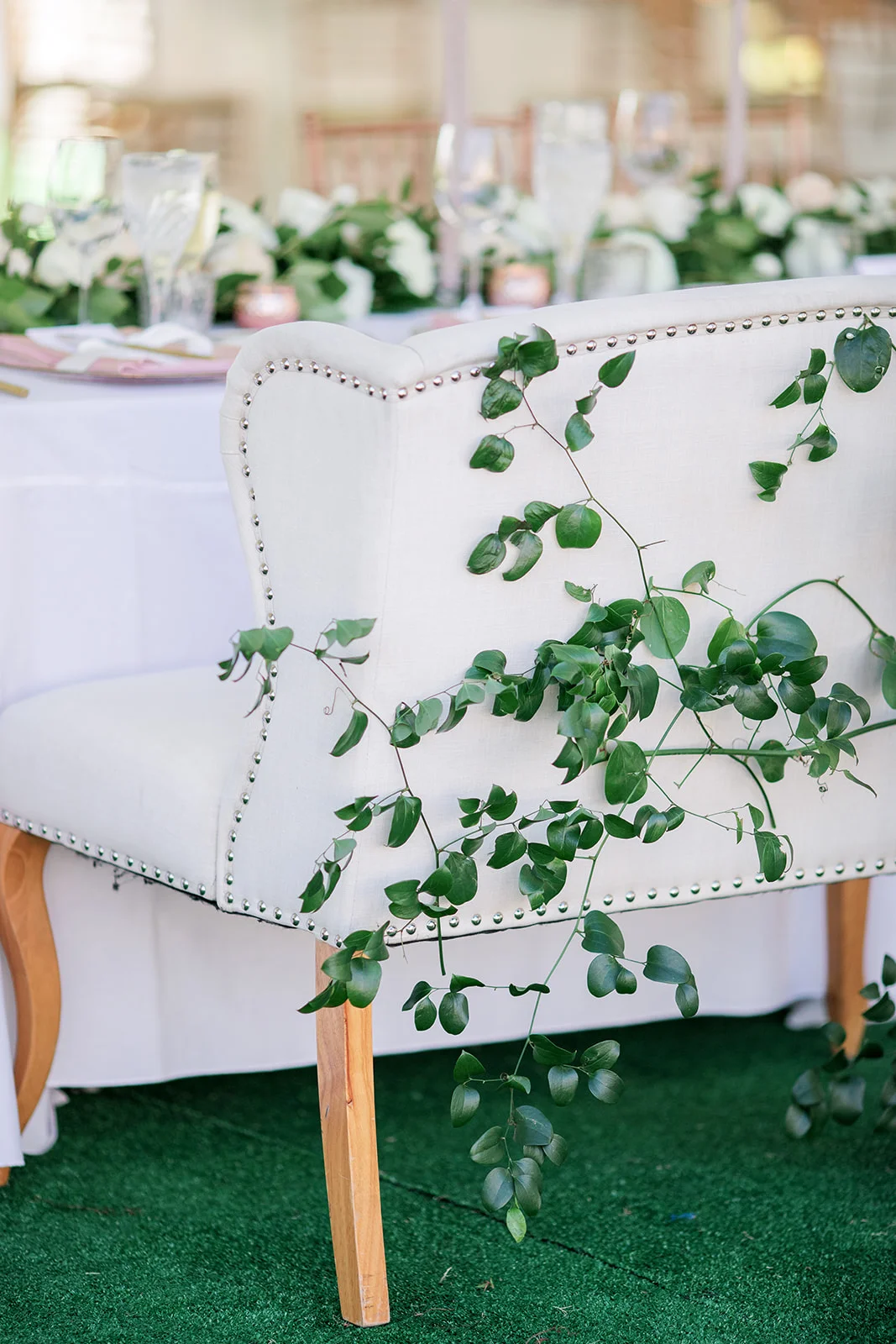 Greenery covered sweetheart chair | Rancho Santa Fe Golf Club | Compass Floral | Wedding Florist in San Diego and Southern California | Rachael McCall Photography
