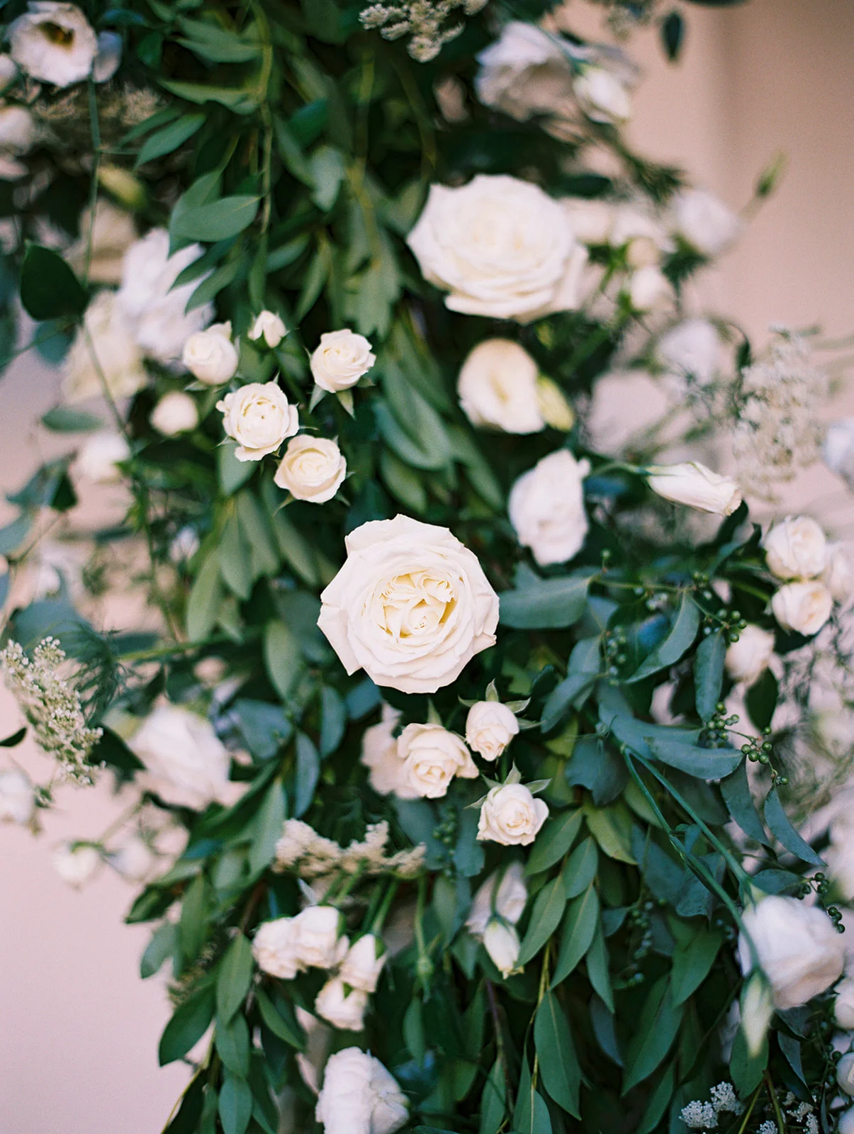 White flowers and smilax covered rounded wedding ceremony arch | Darlington House, La Jolla | Compass Floral | Wedding Florist in San Diego and Southern California | My Sun and Stars Co. Photography