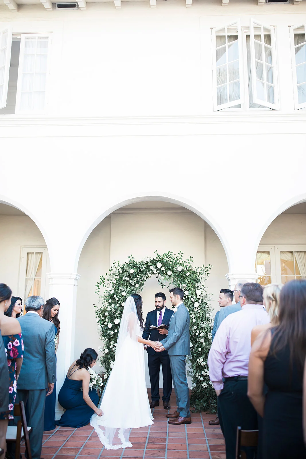 White flowers and smilax covered rounded wedding ceremony arch | Darlington House, La Jolla | Compass Floral | Wedding Florist in San Diego and Southern California | My Sun and Stars Co. Photography
