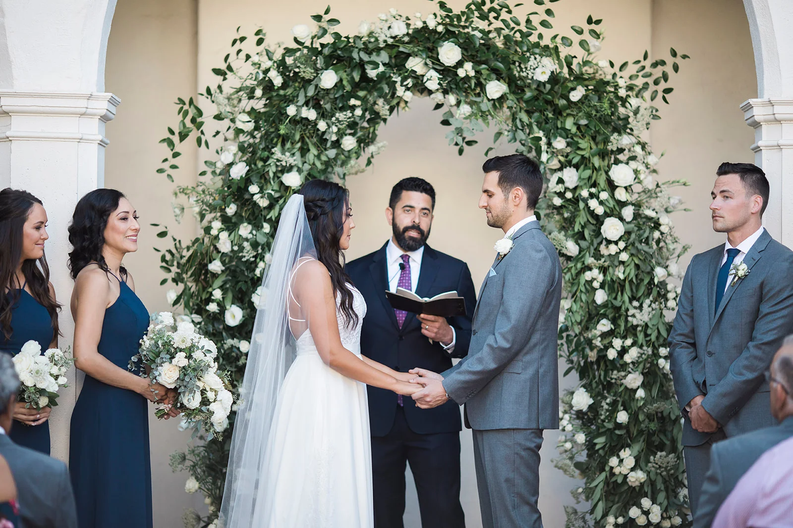 White flowers and smilax covered rounded wedding ceremony arch | Darlington House, La Jolla | Compass Floral | Wedding Florist in San Diego and Southern California | My Sun and Stars Co. Photography