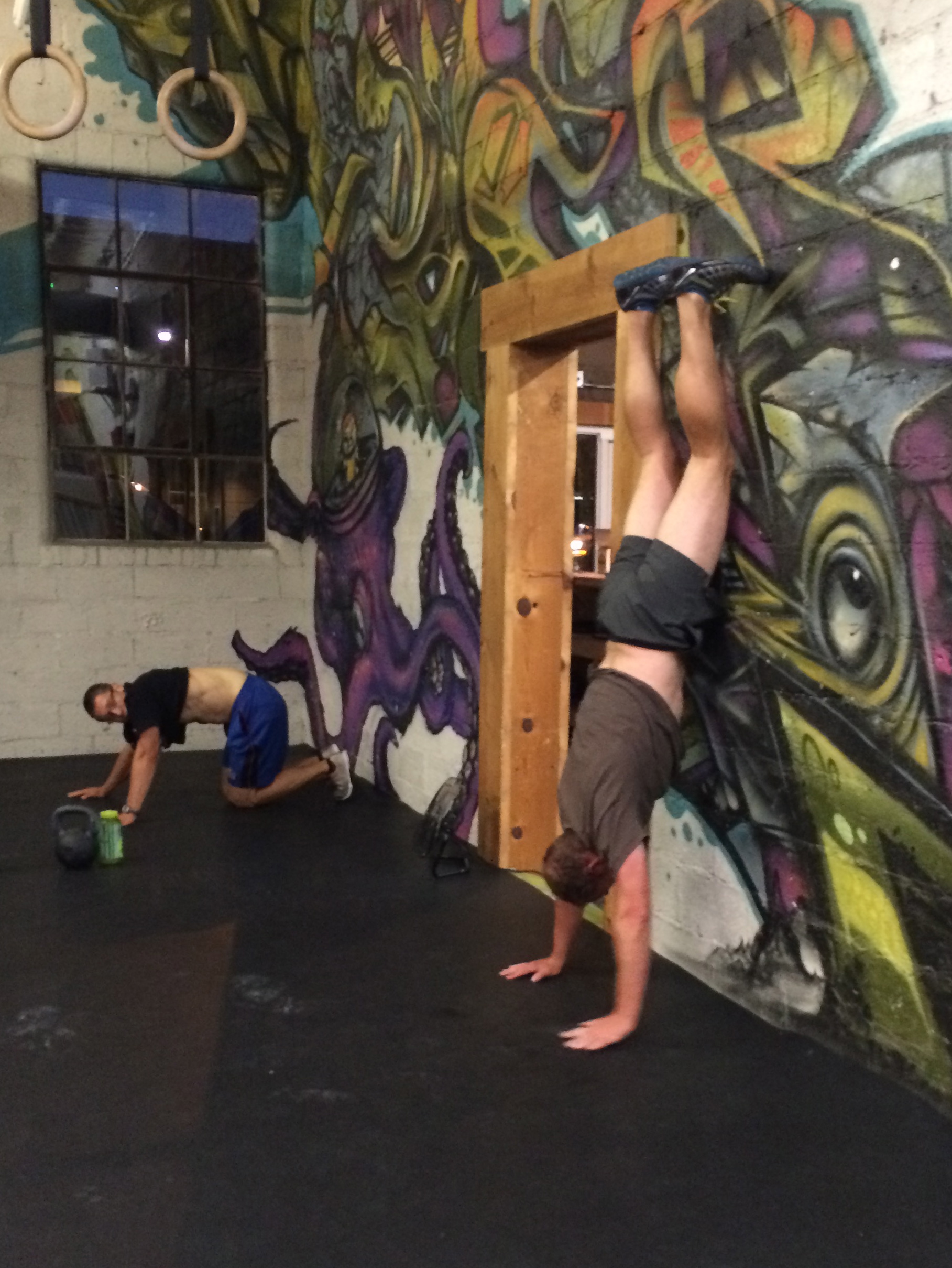Wall walks and handstands are great things to practice during open gym. here jacob watches in disgust as darren nails wall walks on wednesday.