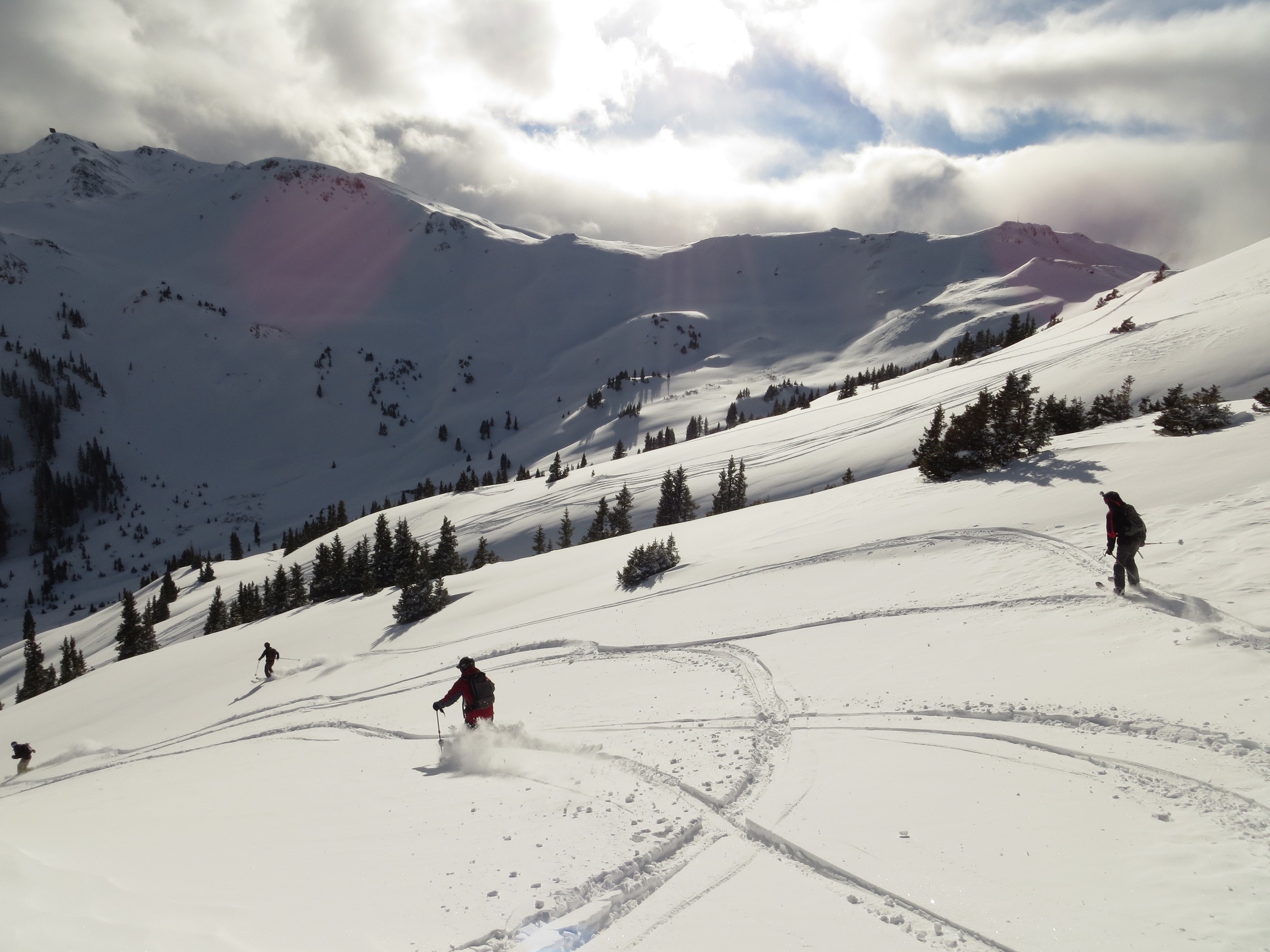 Friends skiing fresh San Juan powder near Red Mountain Pass