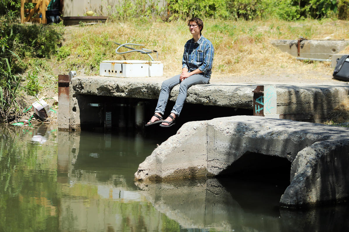 Brian Tonetti, of the Seven Canyons Trust, talks about a proposal to "daylight" the confluence of three Salt Lake Valley creeks — Emigration, Red Butte and Parleys — on Wednesday, May 31, 2017. Tonetti is sitting at the confluence where the creeks empty into the Jordan River at about 1300 South and 900 West. Photo: Scott G Winterton, Deseret News.