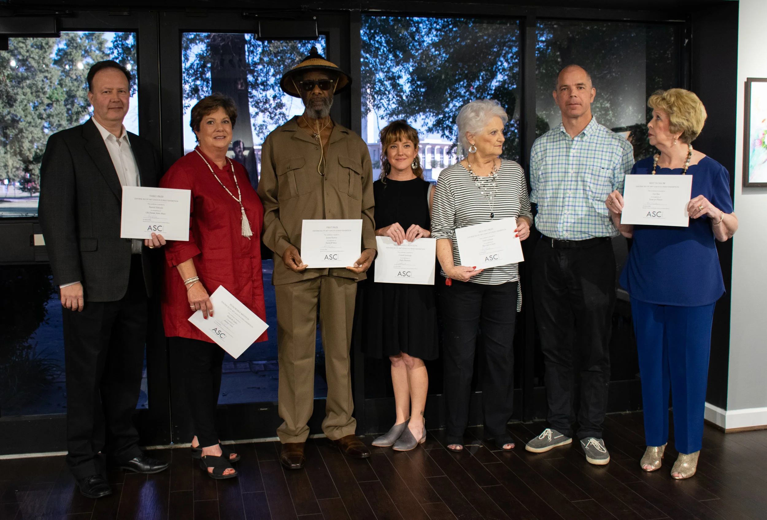 The winners of the 2018 Pine Bluff Art League Annual Exhibition are (from left) Patrick Edwards (Third Place), Elizabeth Sadler (Honorable Mention), Jimmie L. Burton (First Place), Crystal Jennings (Honorable Mention), Dell Gorman (Second Place), Juror John Kushmaul, and Inis Ray (Best in Show).