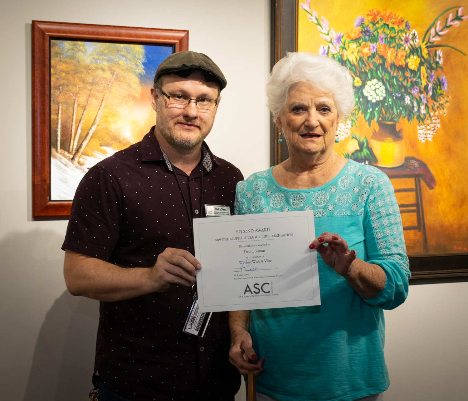  Dell Gorman (right, with juror Ricky Sikes) was awarded Second Place for her acrylic painting  Window With A View . 