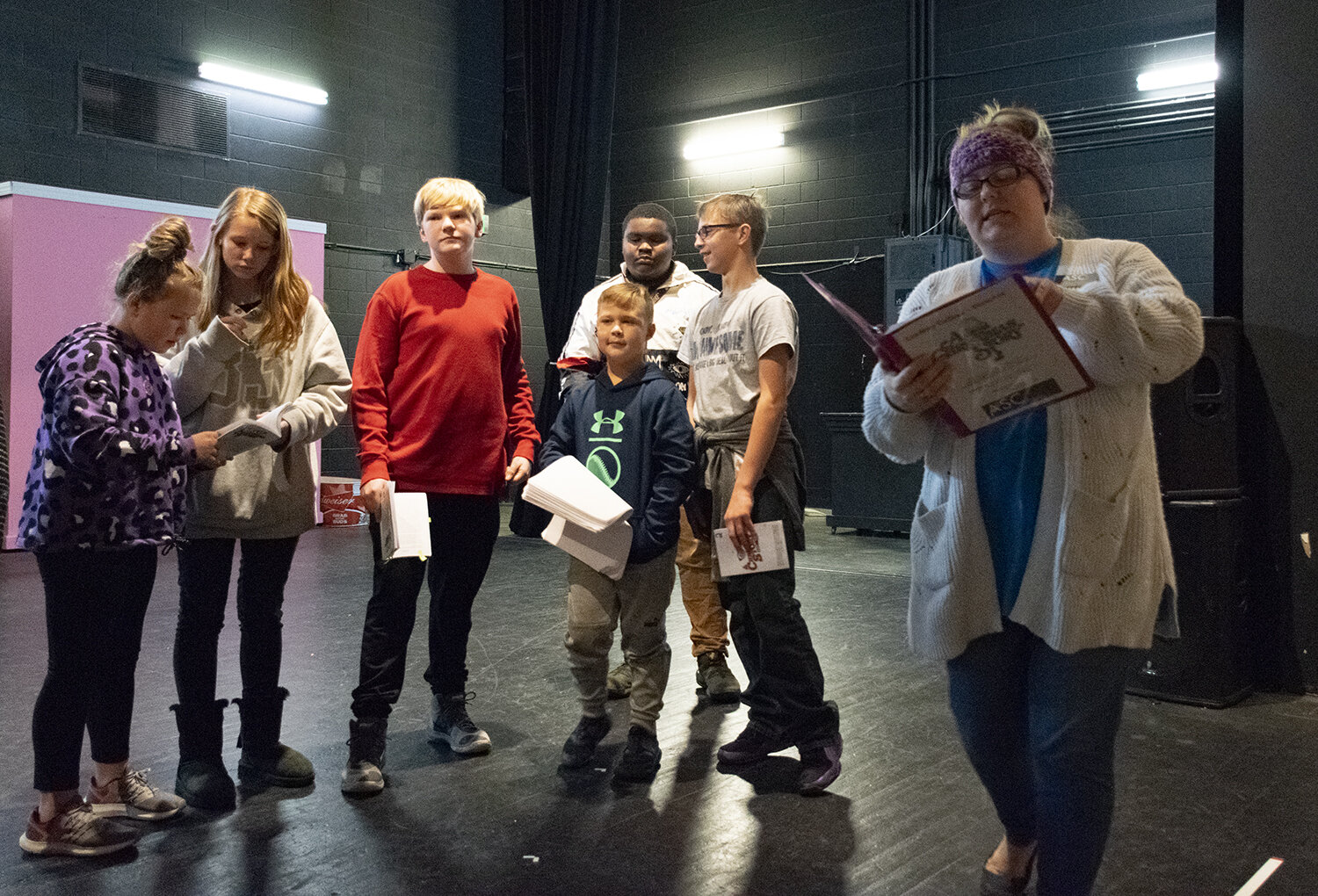  “A Christmas Story” director and ASC Theater Education Coordinator Lindsey Collins (right) leads young cast members through a scene during rehearsals.  