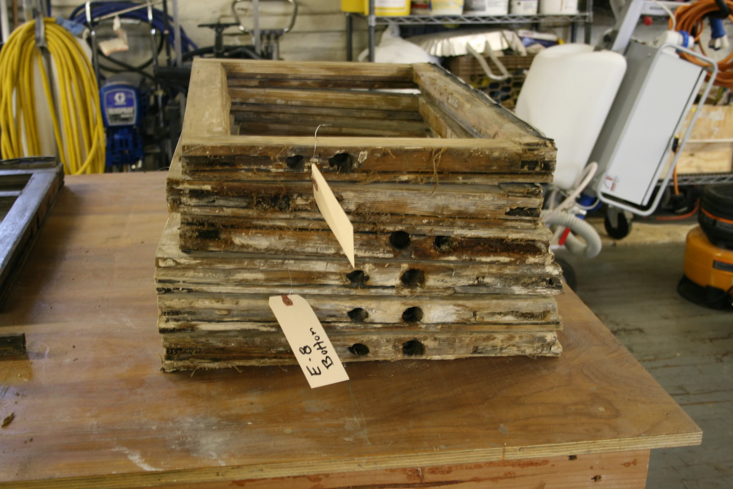 Pictured above: the windows after removal from the house, in their original, deteriorated condition. Here we began the arduous task of labeling and numbering each sash in order to return each one to its original location. 