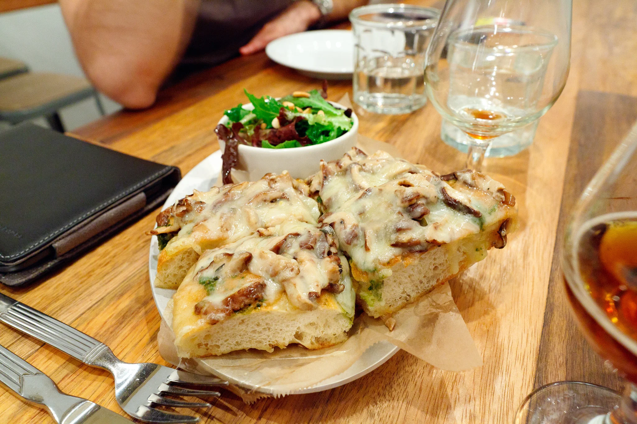 Fontina Val d'Aosta - Marinated mushrooms and basil pesto open-face on focaccia with green salad and toasted pine nuts