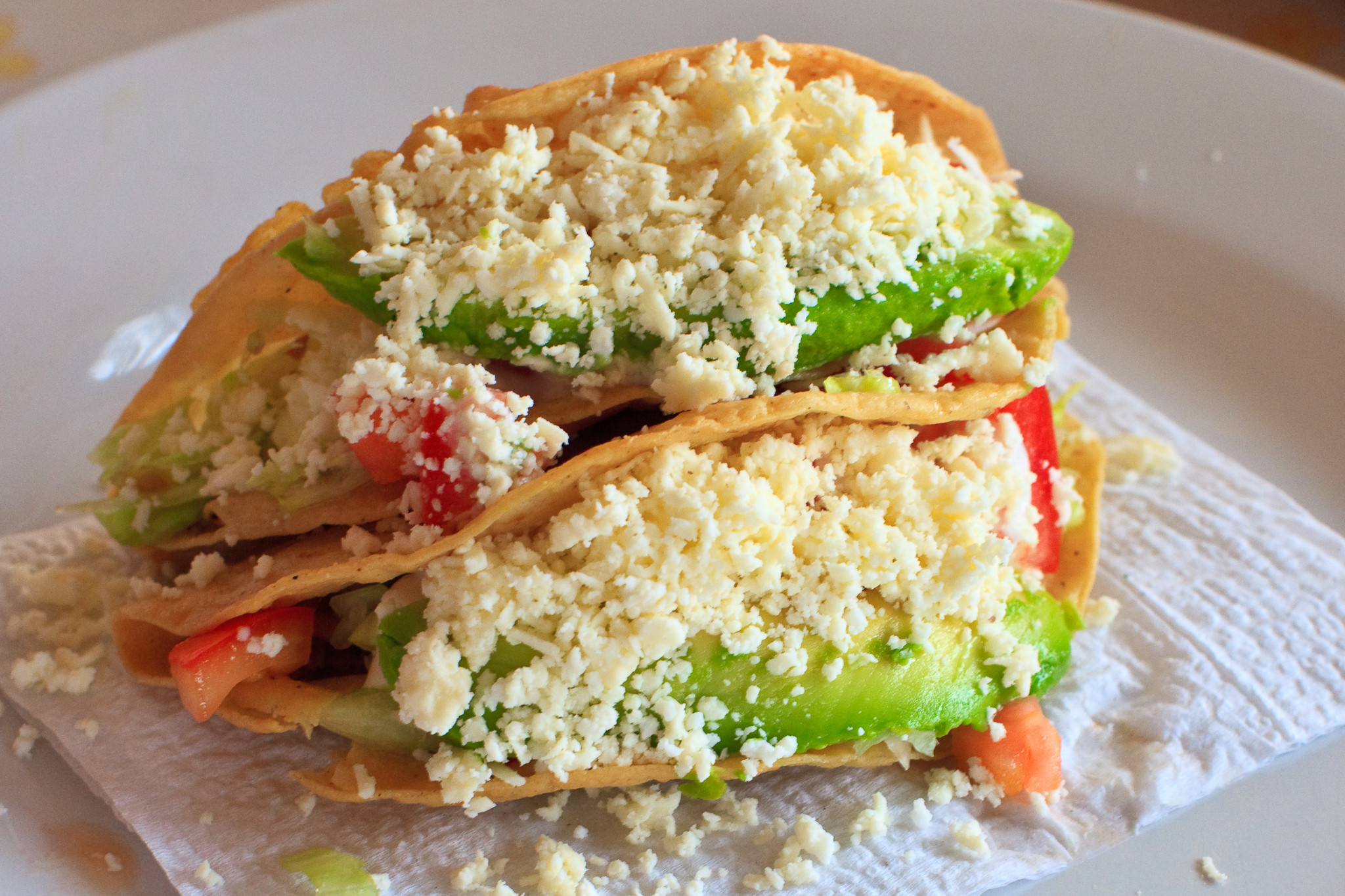 Los Tacos Dorados Up Close, Overflowing with Avocado