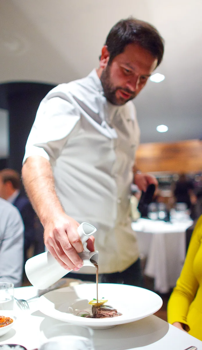 4th Course: Chef Olvera serving bald pig from Yucatán, pork reduction with bean salsa, chile, radish
