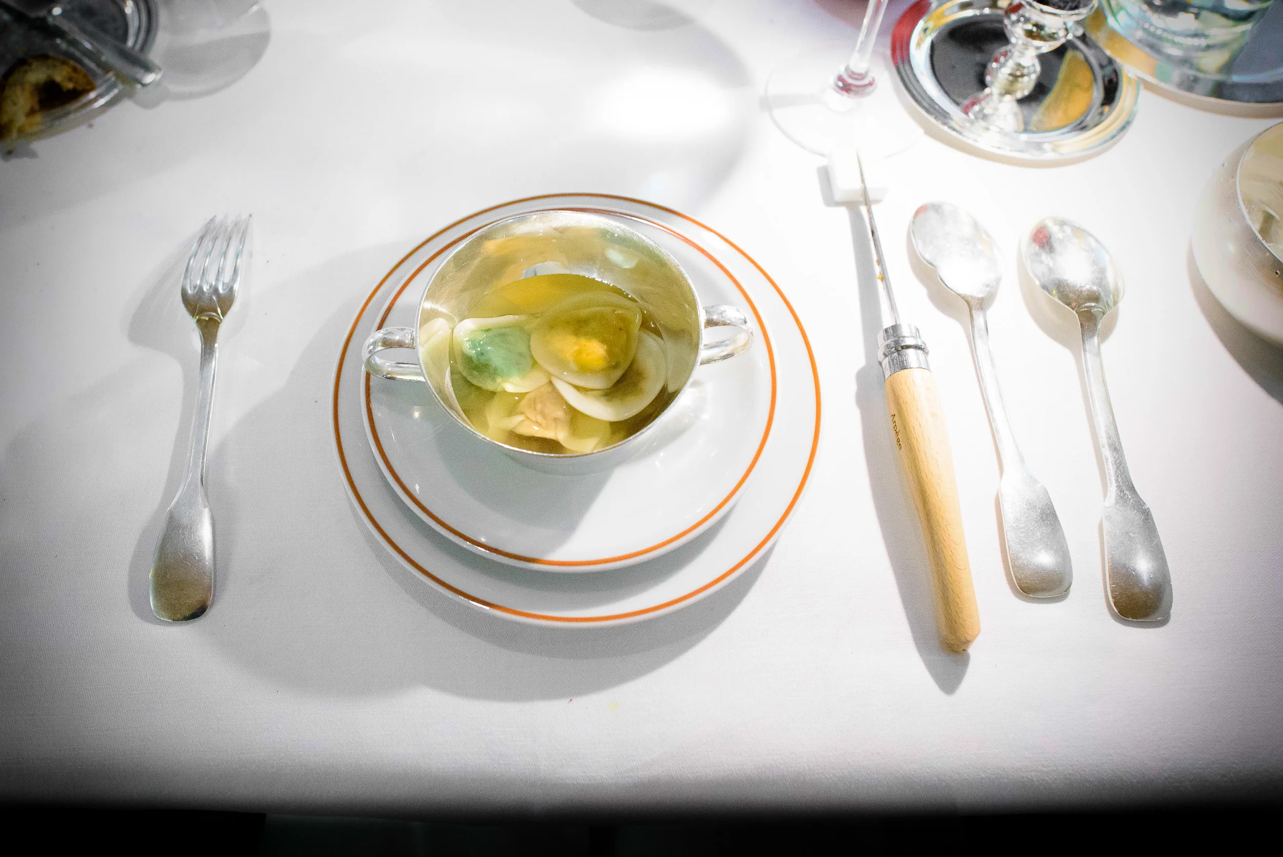 10th Course: Fines raviolis potagères multicolores, consommé v
