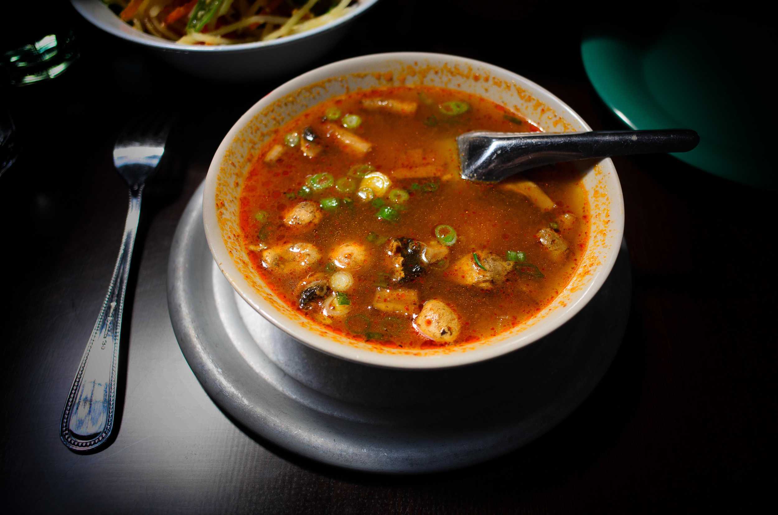 Tom yum (lemongrass) soup: savory sour soup w/ mushrooms, tradit