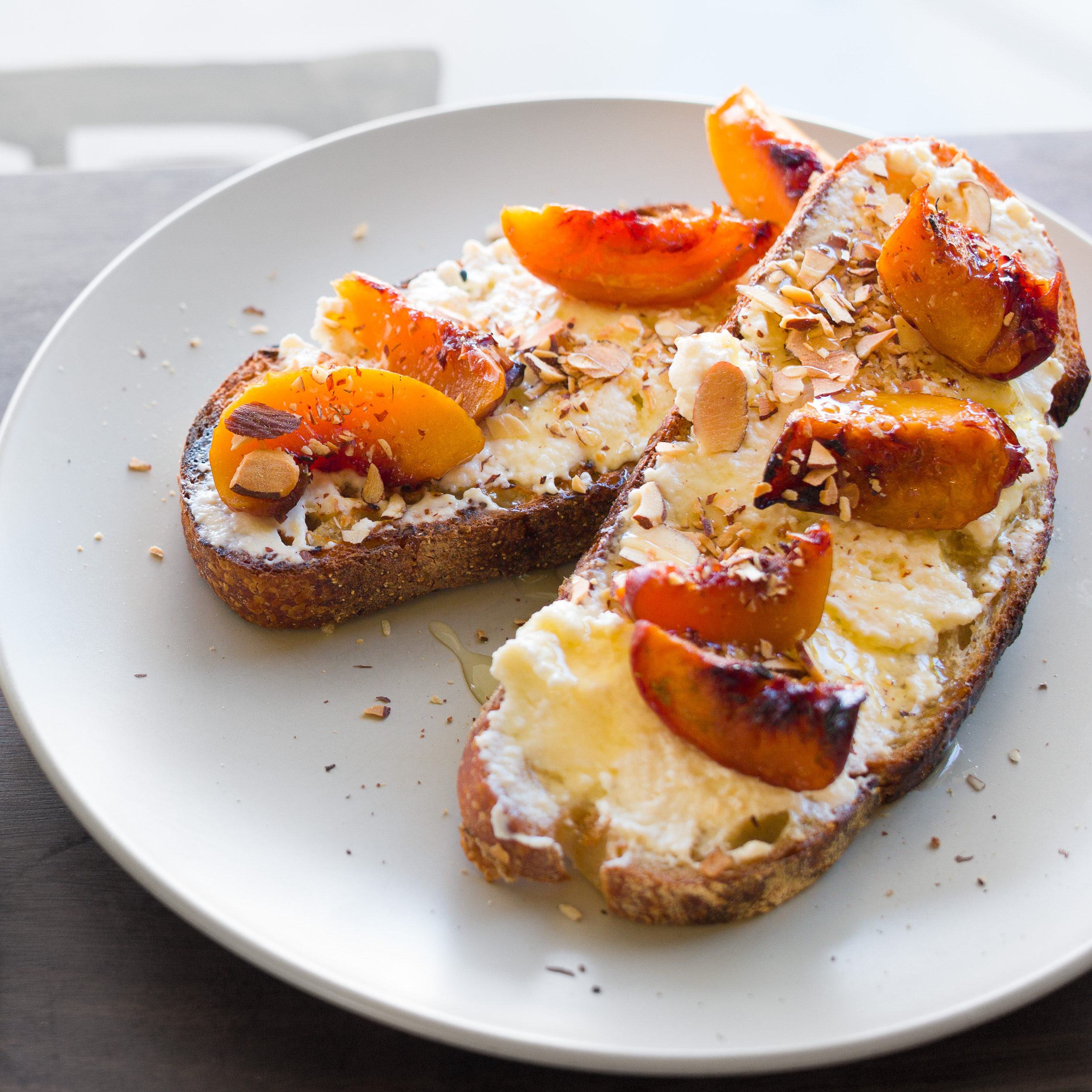 Honey and rosemary-baked stone fruit, local ricotta and almonds