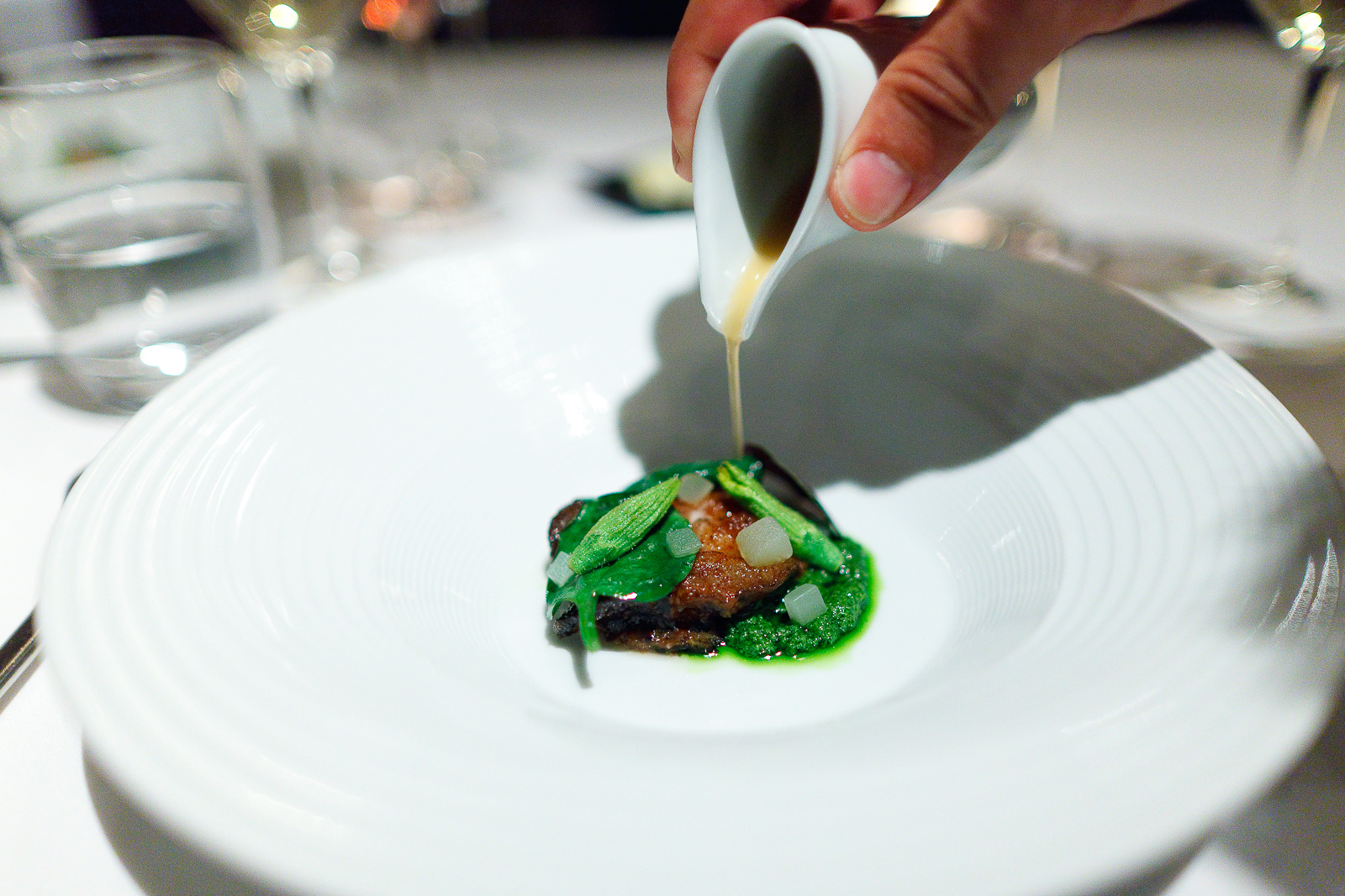 12th Course: Monterey bay abalone cooked in brown butter, pesto of pickled cucumber and walnut, Malabar spinach