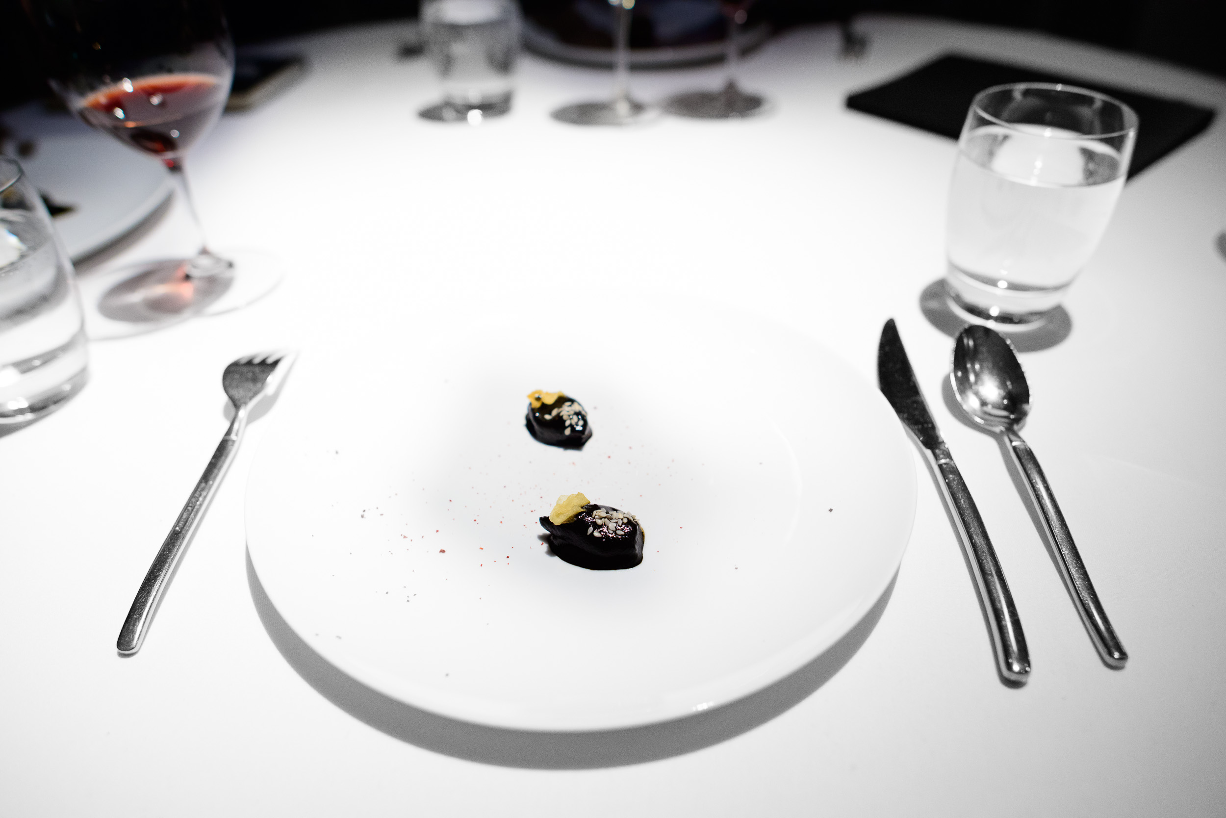 17th Course: Chipirones cooked in their ink, ancho chile, sesame