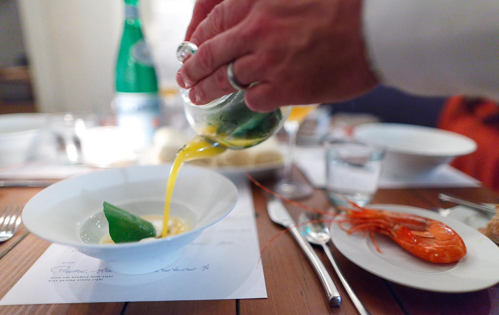 4th Course: Crustacean - Dungeness ragôut gently warmed in crustacean butter. Santa barbara sea urchin, wild nasturtium leaf roasted over the fire until crisp. Crustacean bouillion of lobste