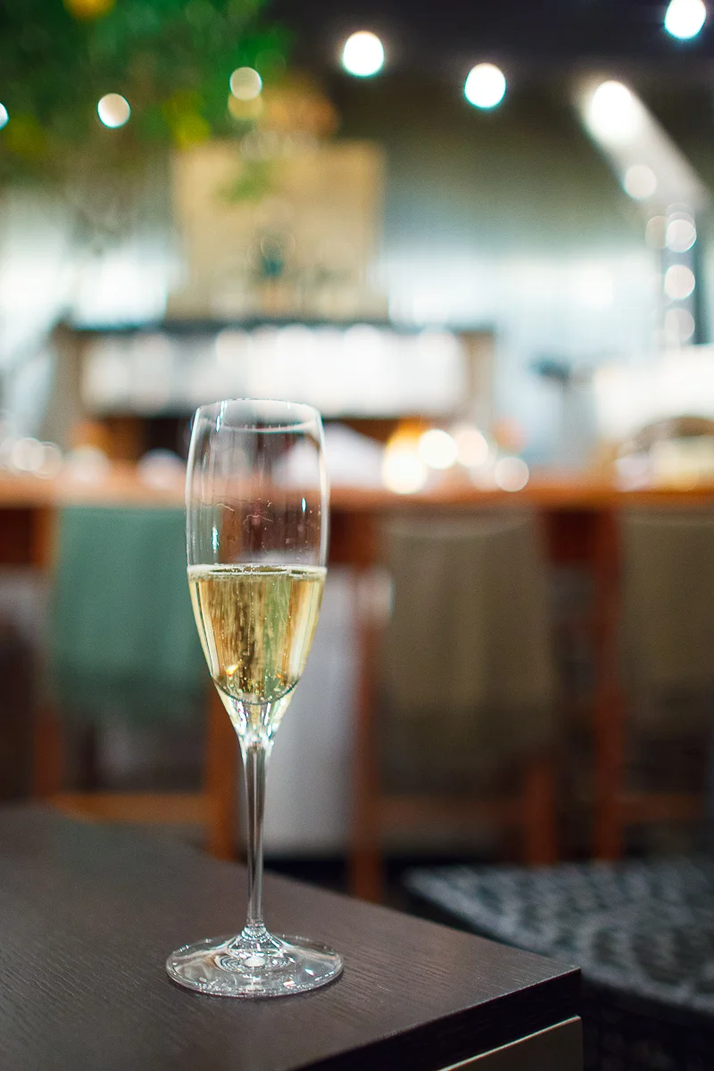 Glass of Champagne Collett in front of the woodfire hearth