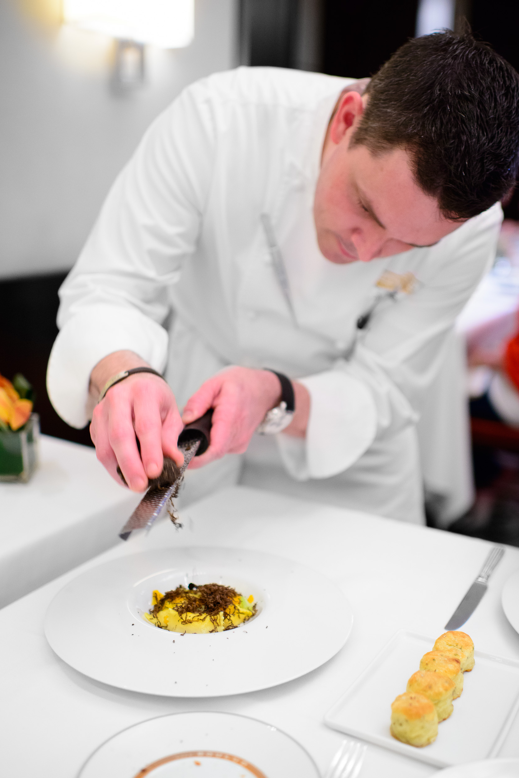 Chef Gavin Kaysen shaving black truffle over the celery root agn