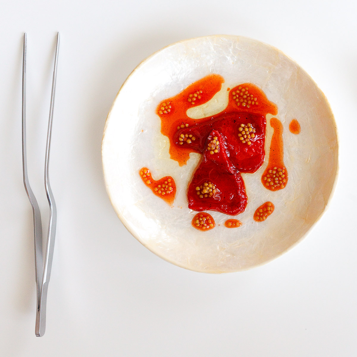 4th Course: "Piquillo pepper" - Dehydrated watermelon re-hydrated in charred piquillo sauce, mustard seeds