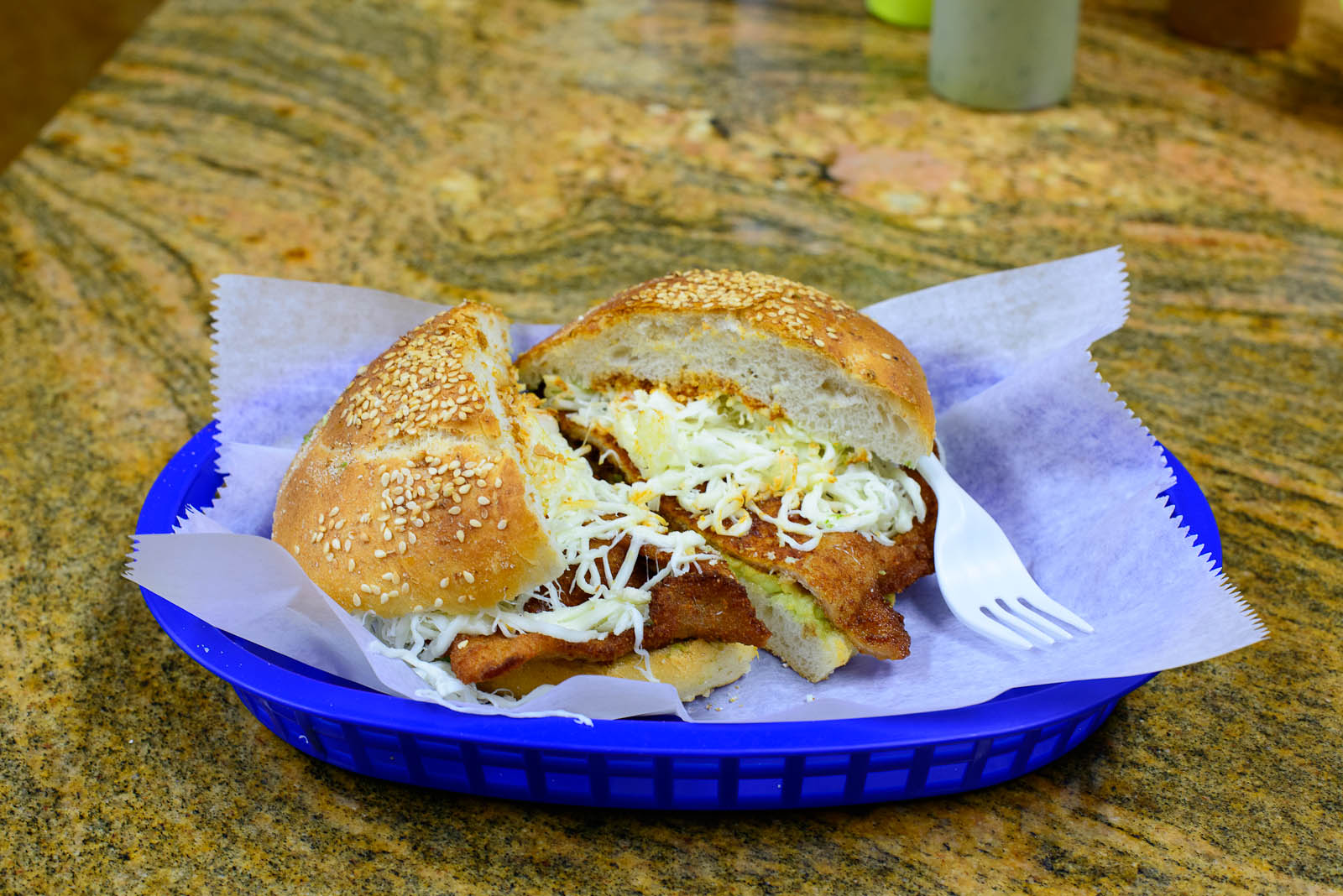 Cemita de milanesa - sesame seed bread layered with avocado, bre