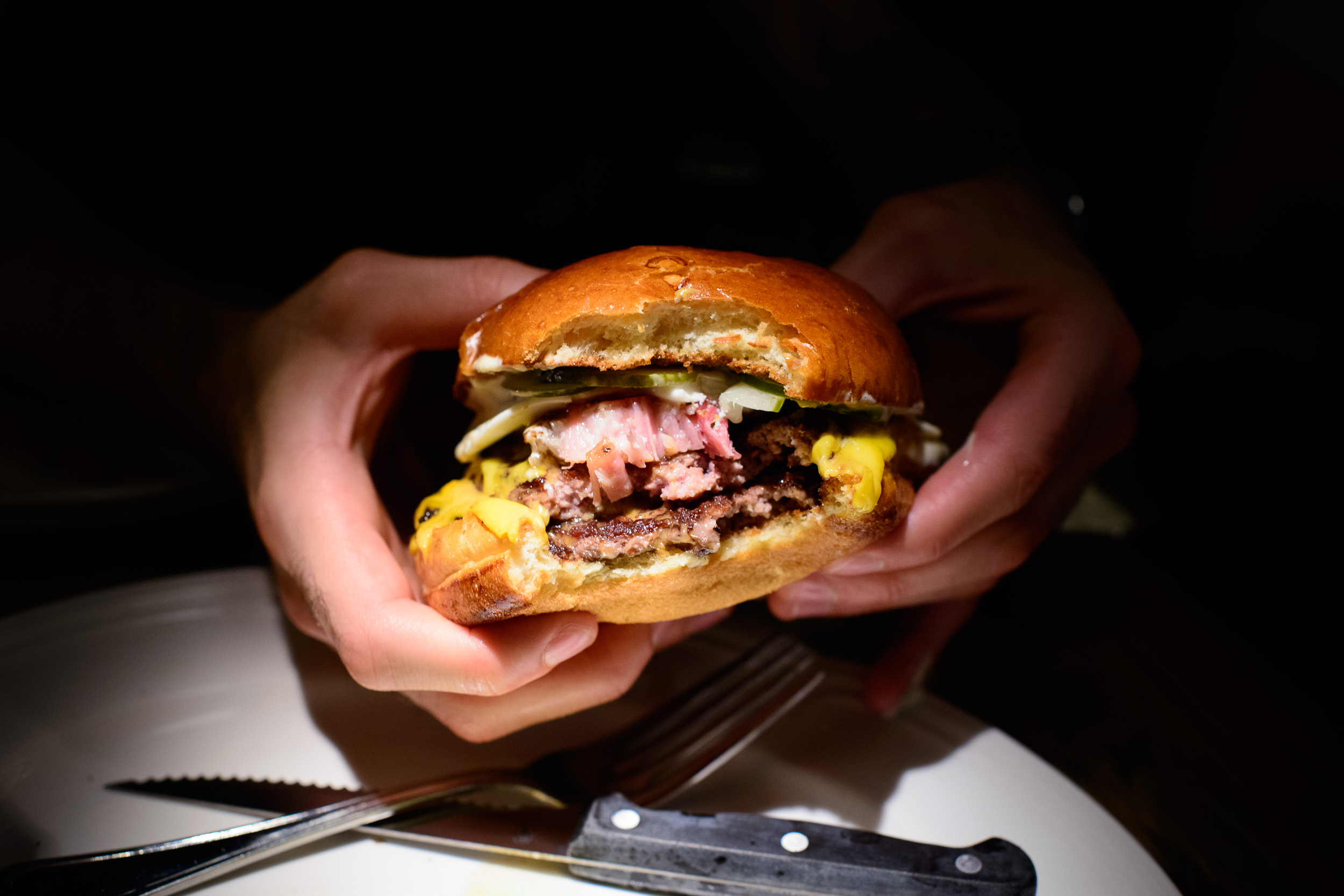 Double cheese burger with fried bacon and egg, up close