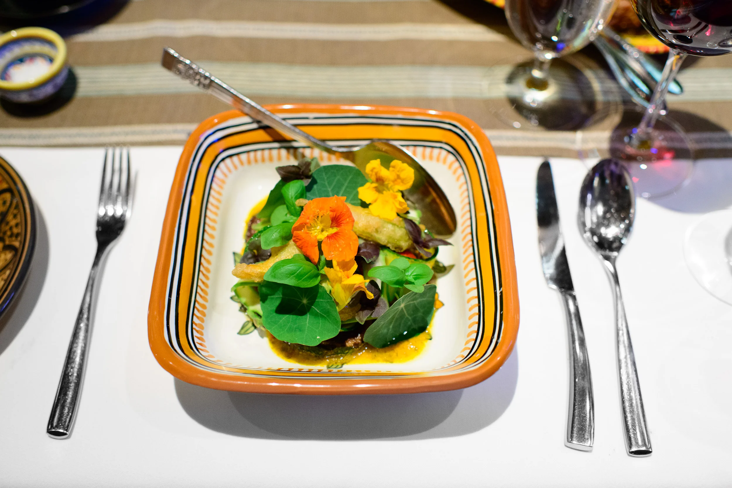 6th Course: Slices of zucchini and squash blossoms in a tomato v
