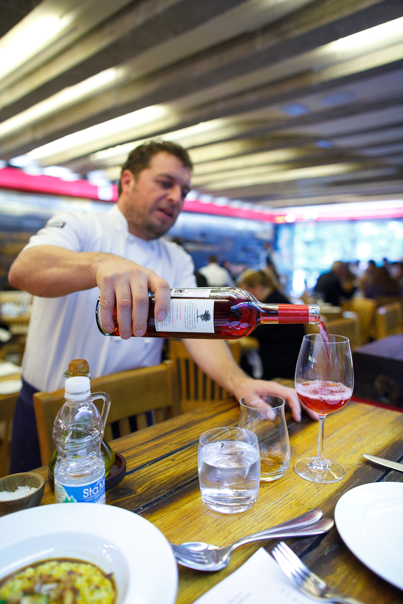 Chef Jair Téllez pours a glass of rosé from Baja California