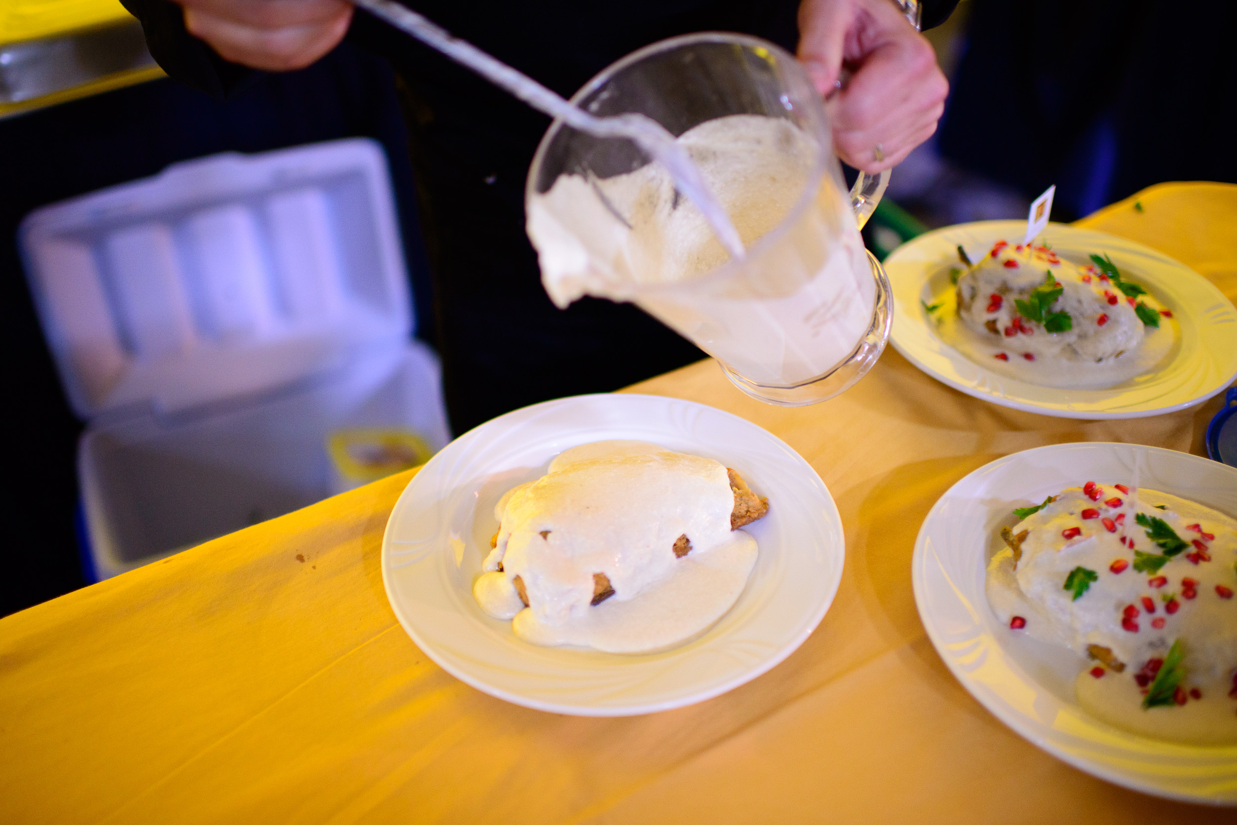 Chef Carlos Zorilla plating his nogada sauce