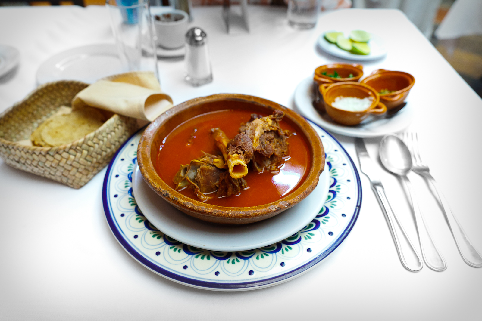 Huaxmole de Puebla - Goat stew garnished with onion, local squash seeds, and cilantro.jpg