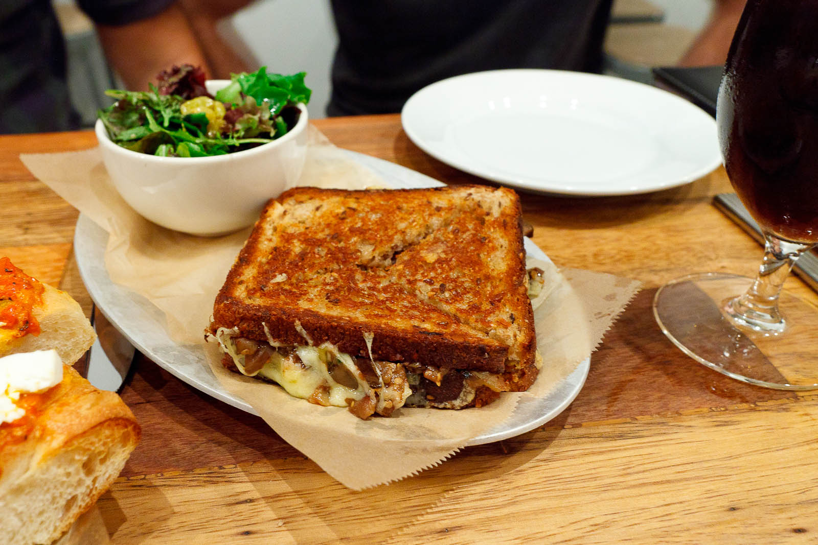 Manchego & Ricotta - minted eggplant and capers on multigrain with green salad and pickled golden raisins ($9)