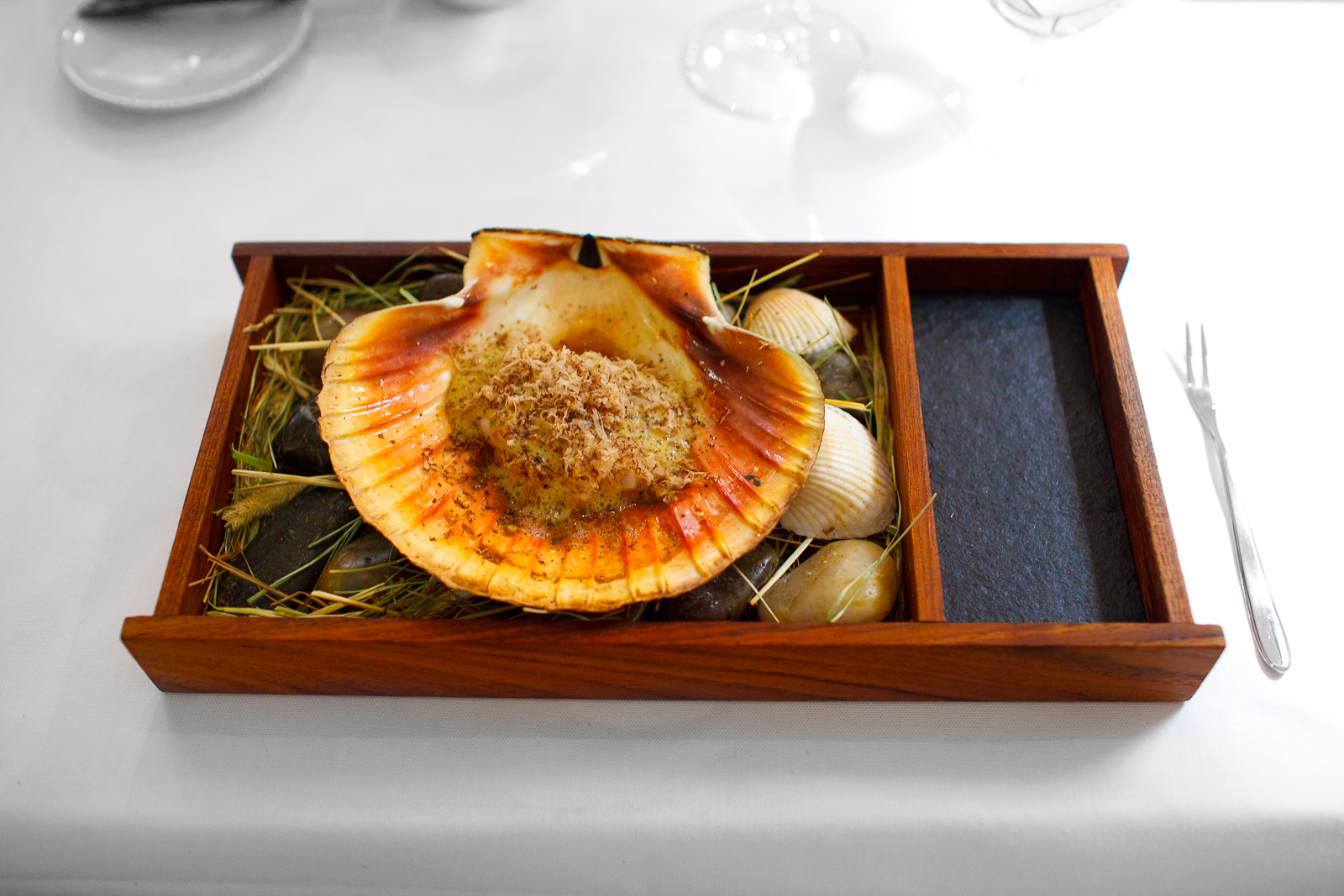 3rd Course: Scallop from Trondheim, Norway in two servings. First, cooked over open fire in its shell with lemon sabayon, truffle, and natural juices.