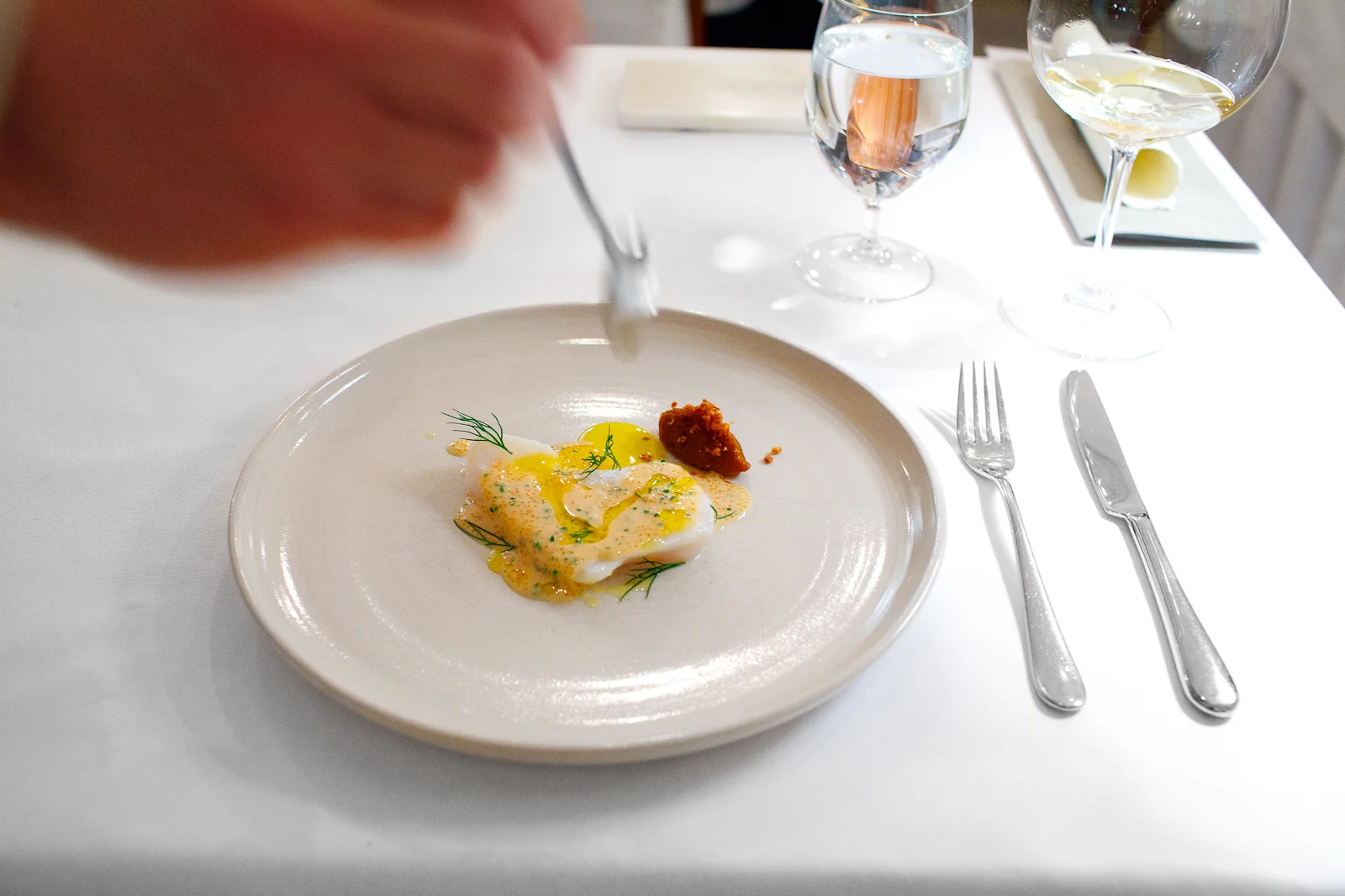 4th Course: Whole wild cod slowly baked under home made pig's fat, with roasted crispy yellow onions, sauce vin blanc flavored with anchovy broth, bleak row from Kalix and chives served