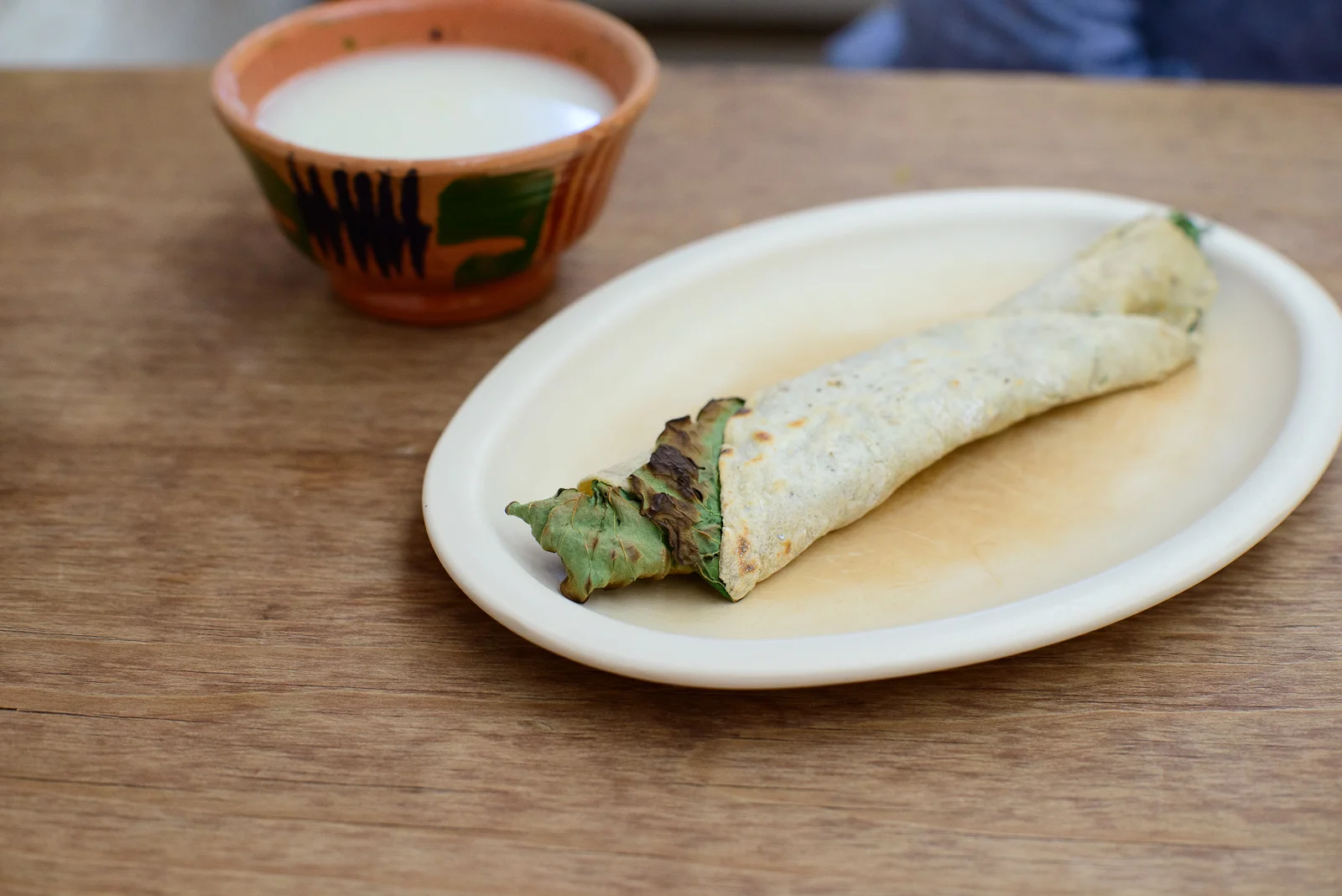 "De eso" - Hoja santa and quesillo wrapped in a corn tortilla