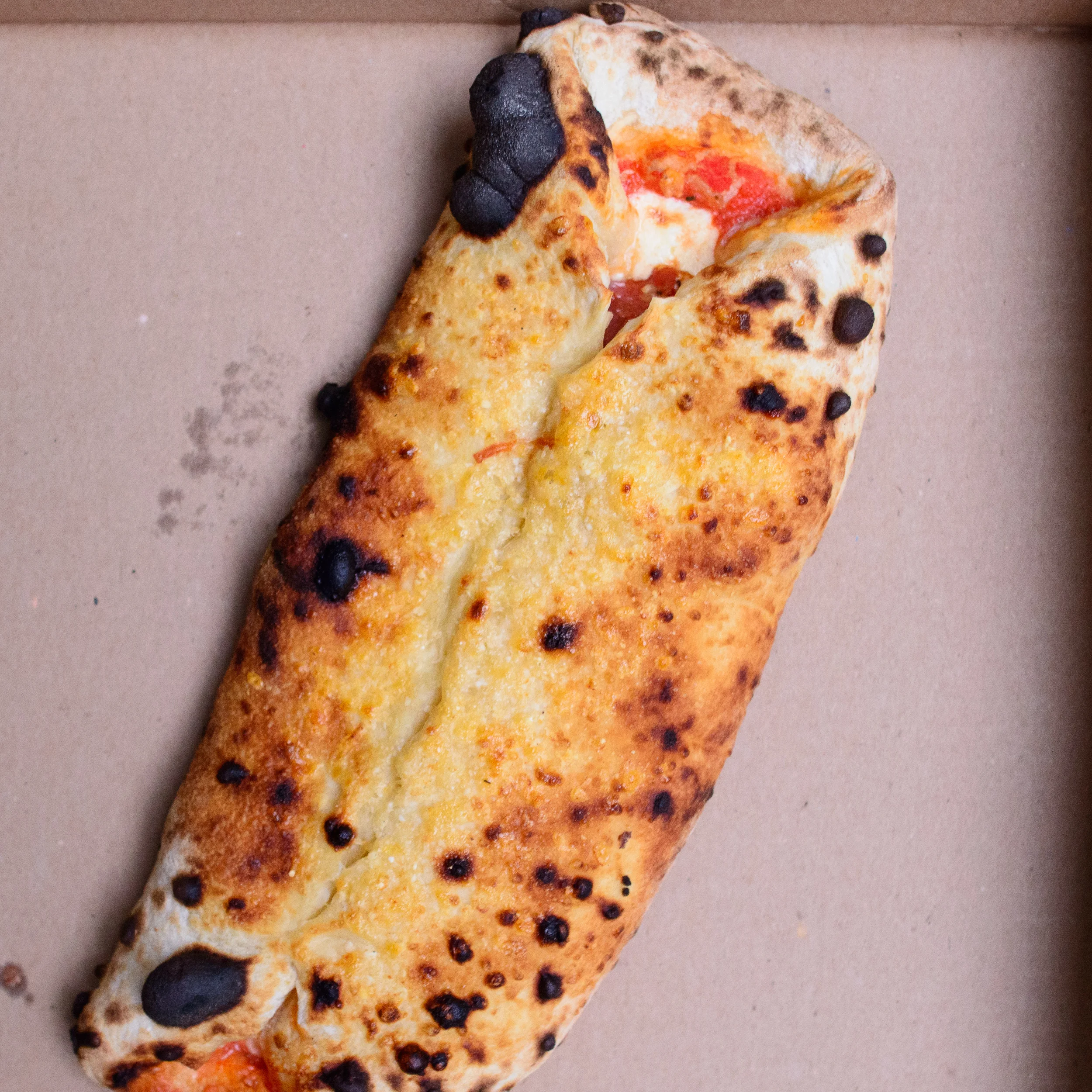 Calzone - tomato, mozzarella, prosciutto cotto, and mushroom