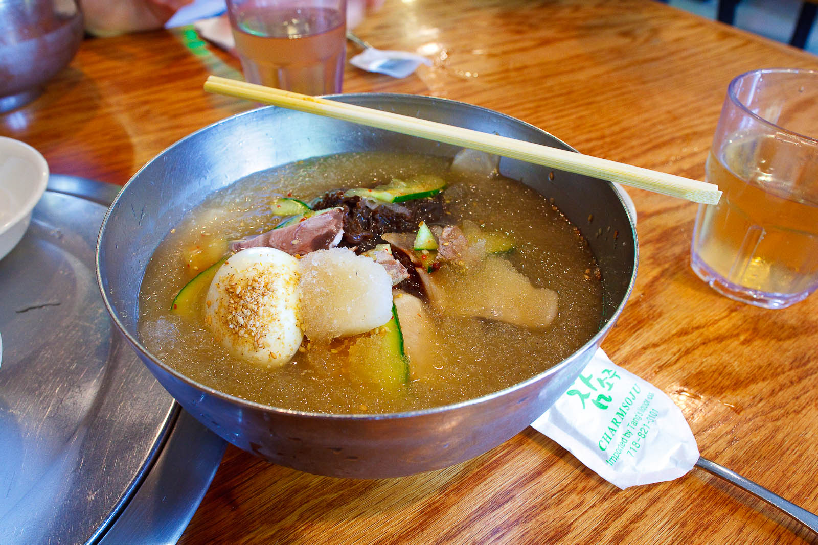 Mul Naeng Myun - Arrowroot starch noodles, sliced beef & vegetables in chilled beef broth, revealing noodles ($8.95)