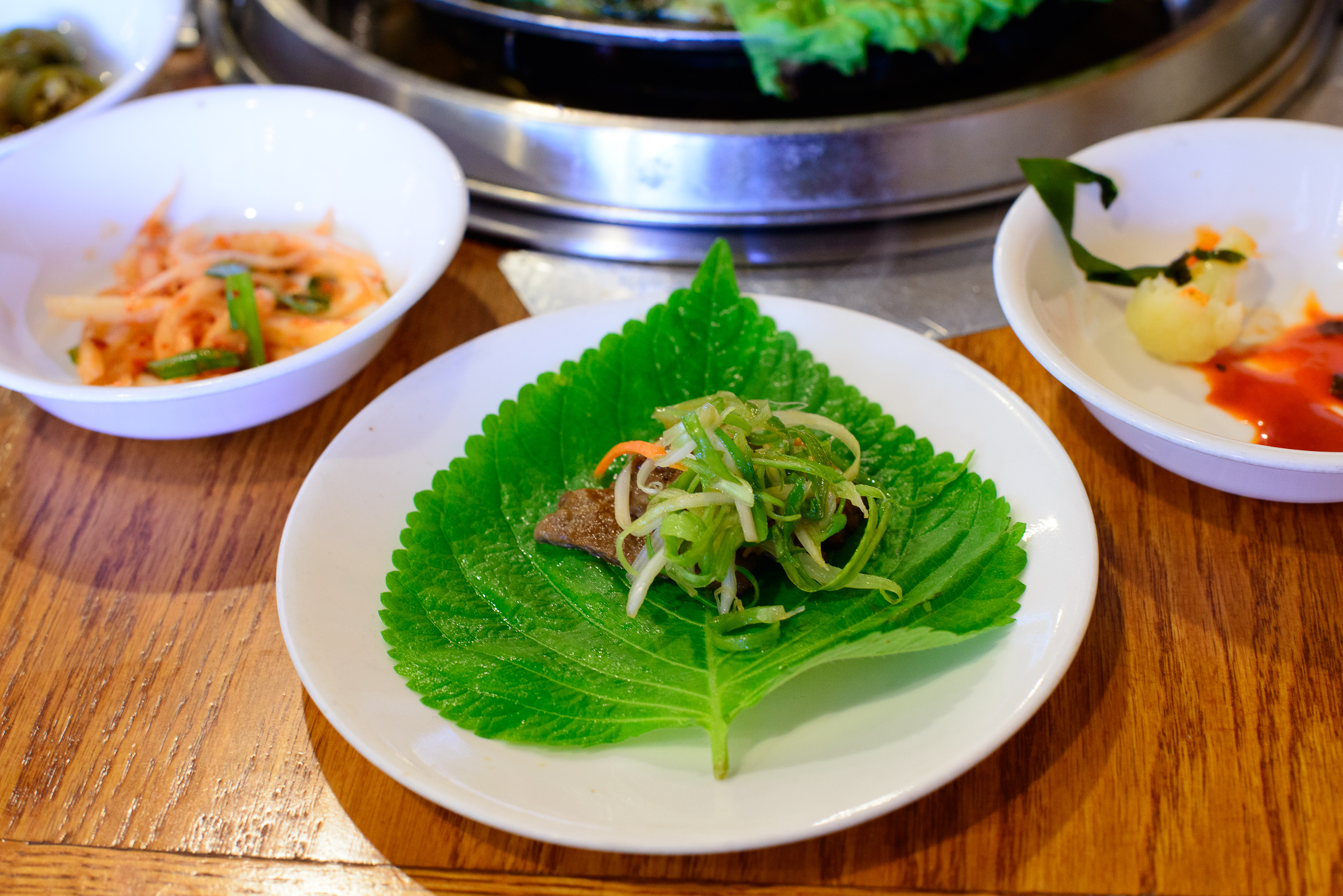 Marinated beef wrapped in sesame leaf with pickled vegetables