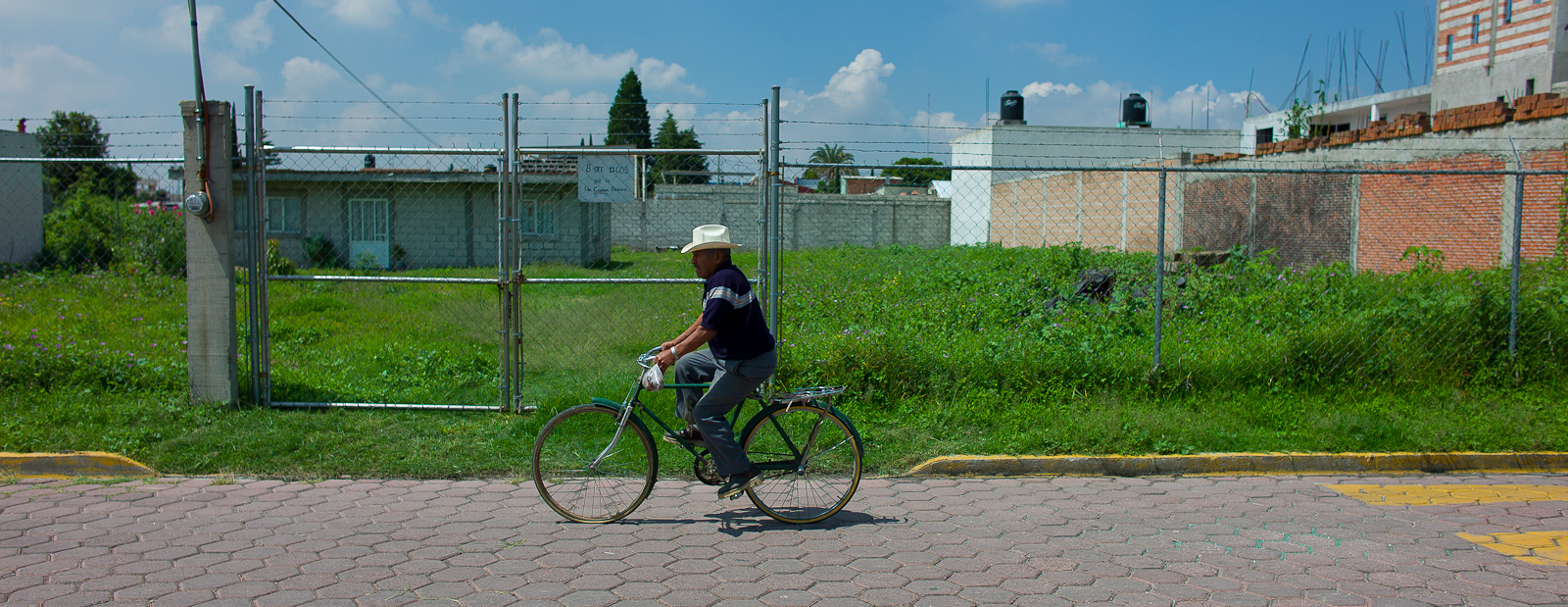 Man on Bike, Empty Lot