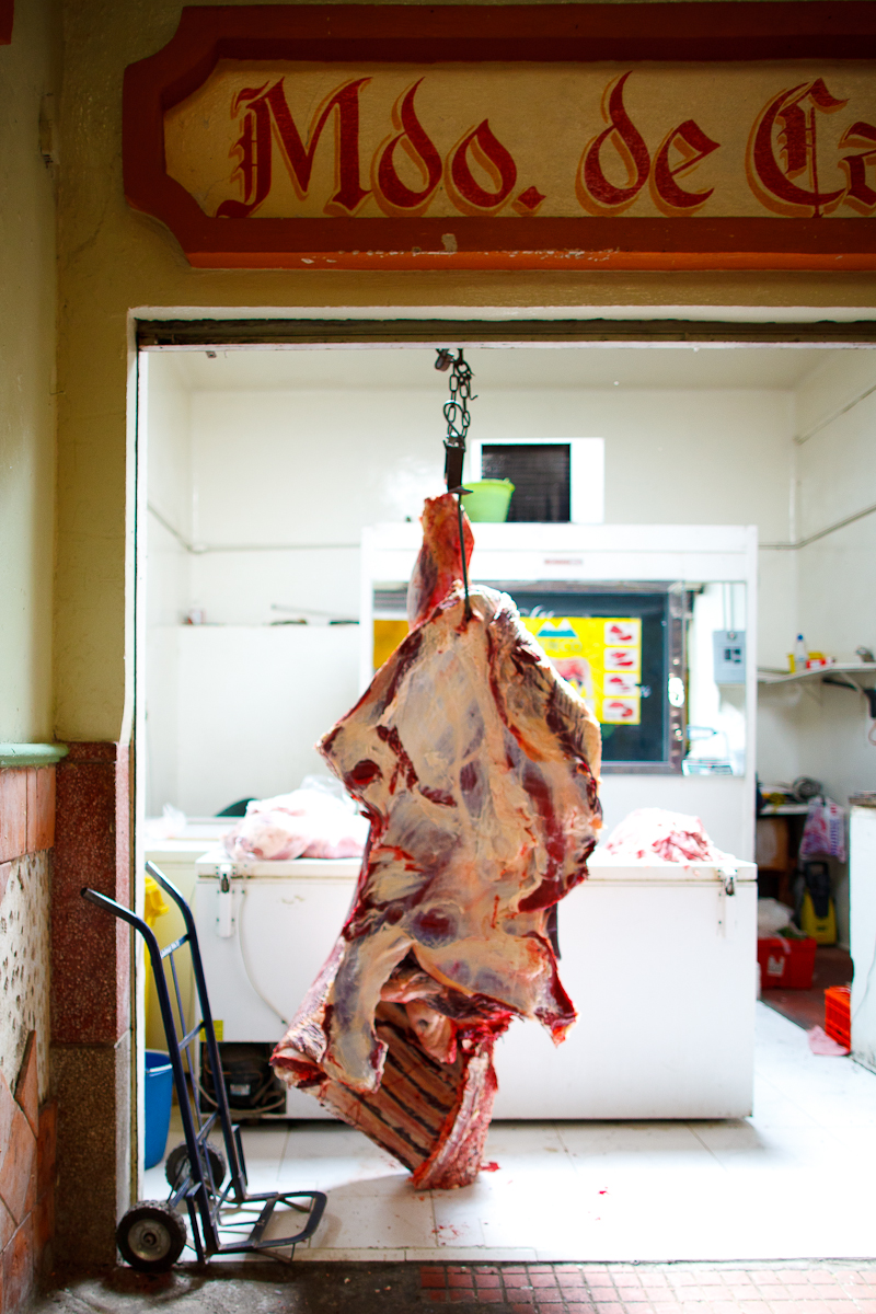 An entire cow, hanging for the butcher. I love how it's touching the ground.