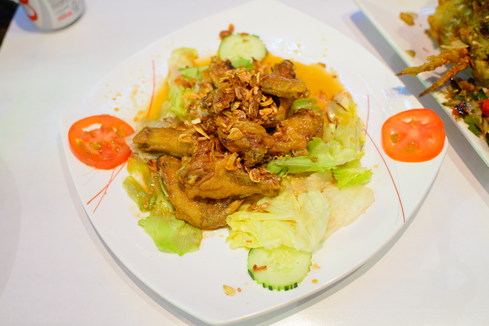 Chicken wings marinated in fish sauce served with salad