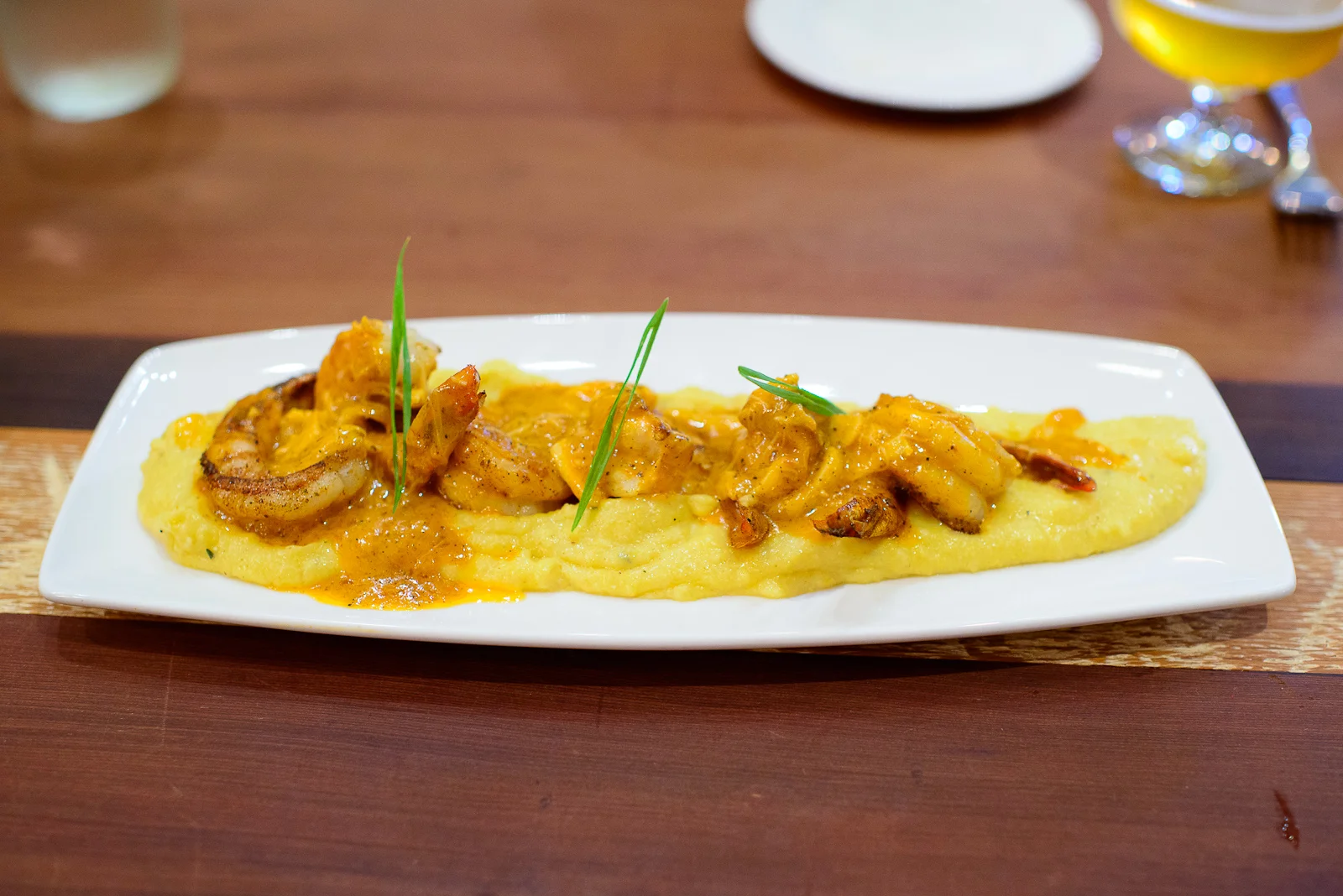 Deep water shrimp & gritz - cheddar grits, crab sauce ($19)