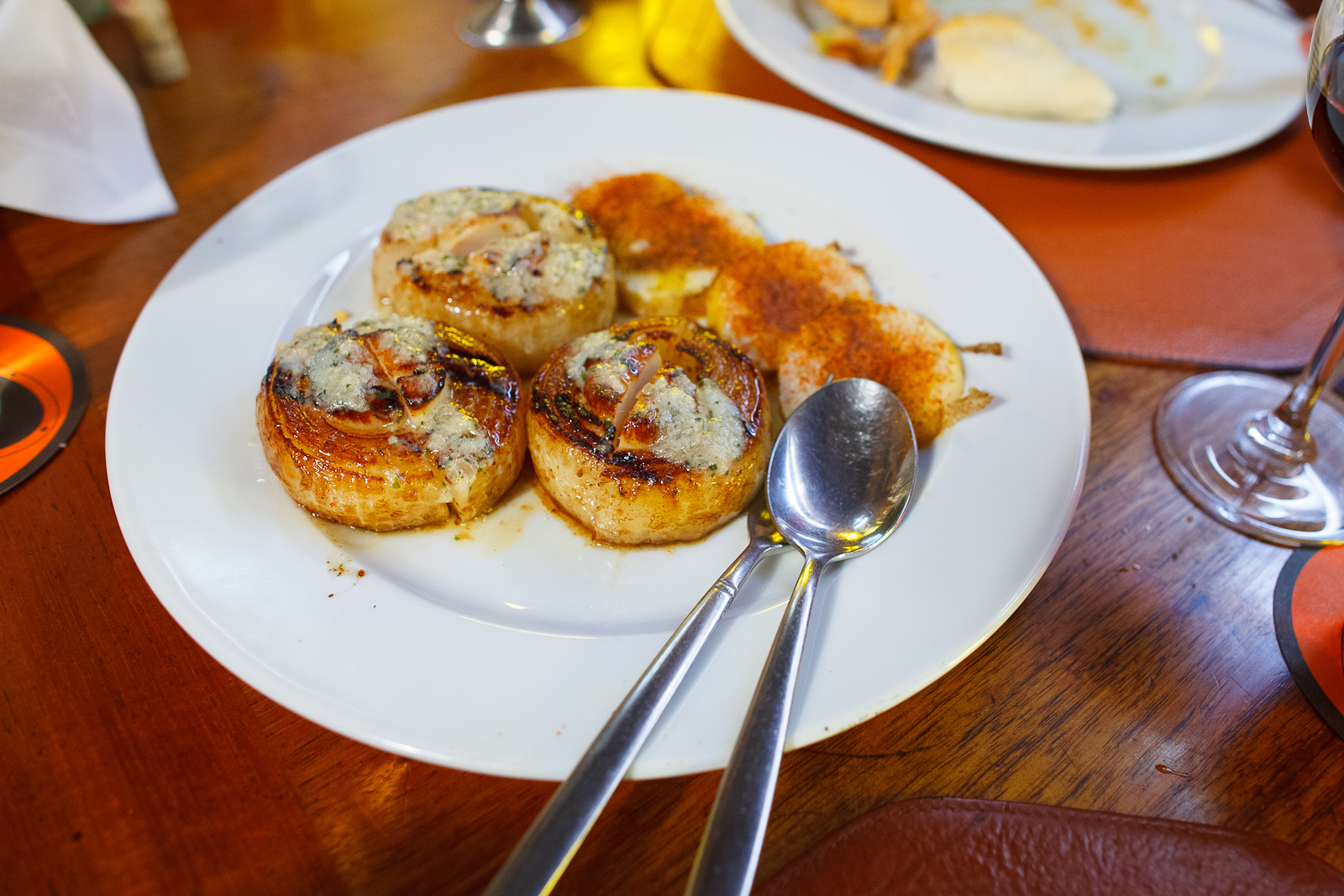 Grilled scallop wrapped in onion, spiced potato slices