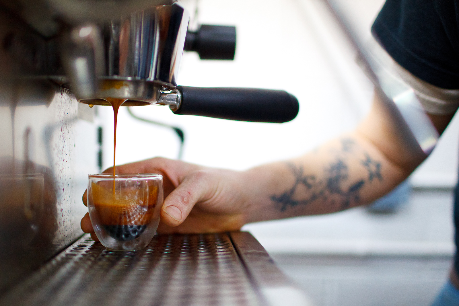 Barista Erich Rosenberg pulling an espresso from three suns beans.jpg