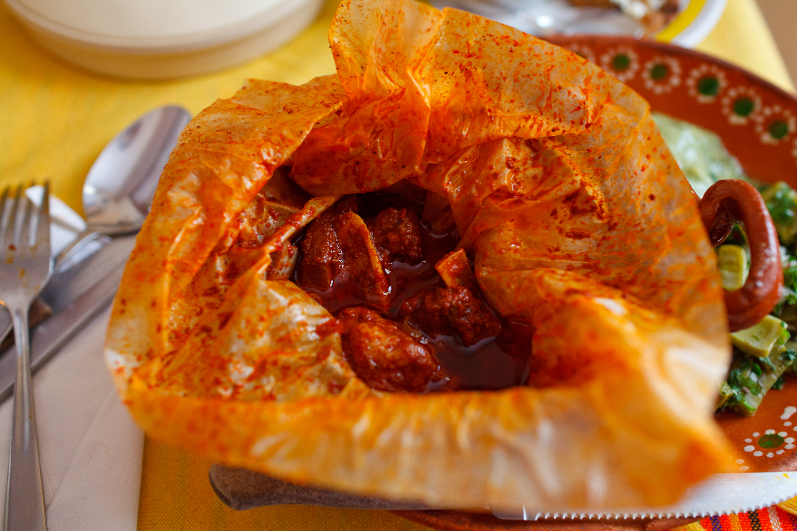 Mixiotes de carnero (Pit-barbecued mutton shank cooked in parchment), bag opened ($103 MXP)