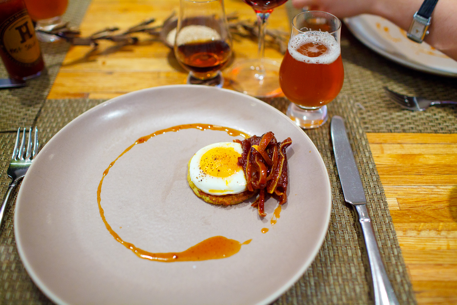 8th Course: Sunny-side up egg on a johnny cake with pig ears.