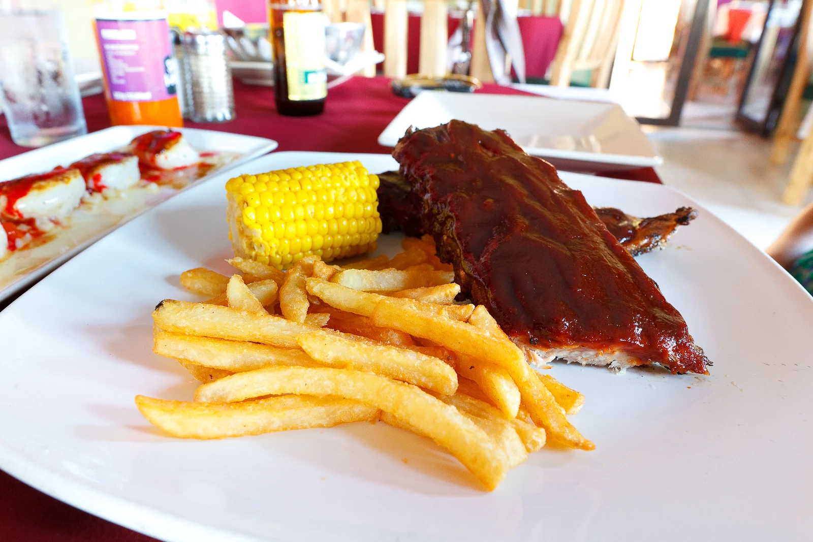 Baby Back Pork Rib, ahumadas y asadas, servidas con elote y papas a la Francesa (Baby back ribs, smoked and grilled, served with corn and french fries) (MXP $200).jpg