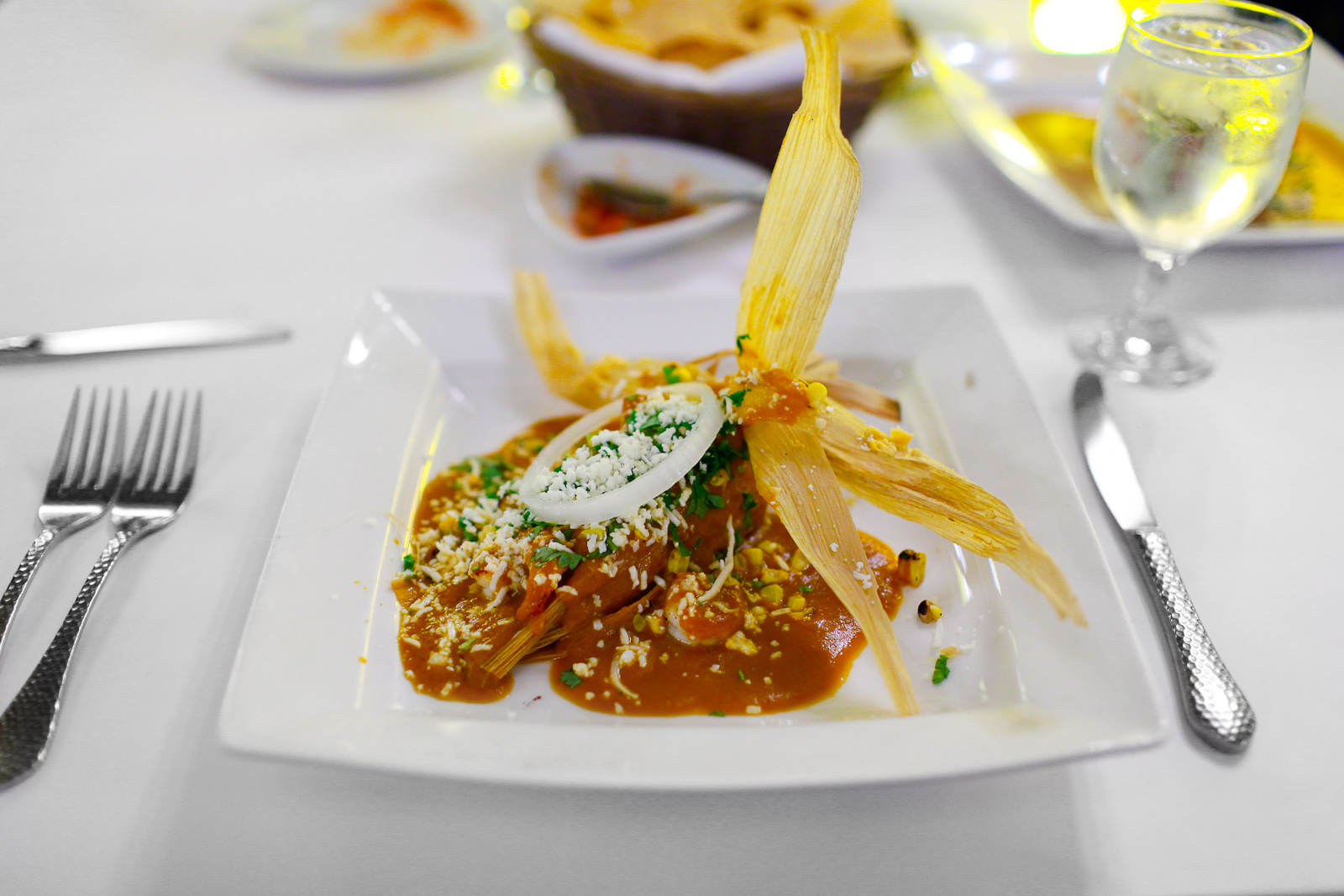 Tamal de elote - fresh corn tamal with seared shrimp, cooked in a chipotle chile cream ($11)