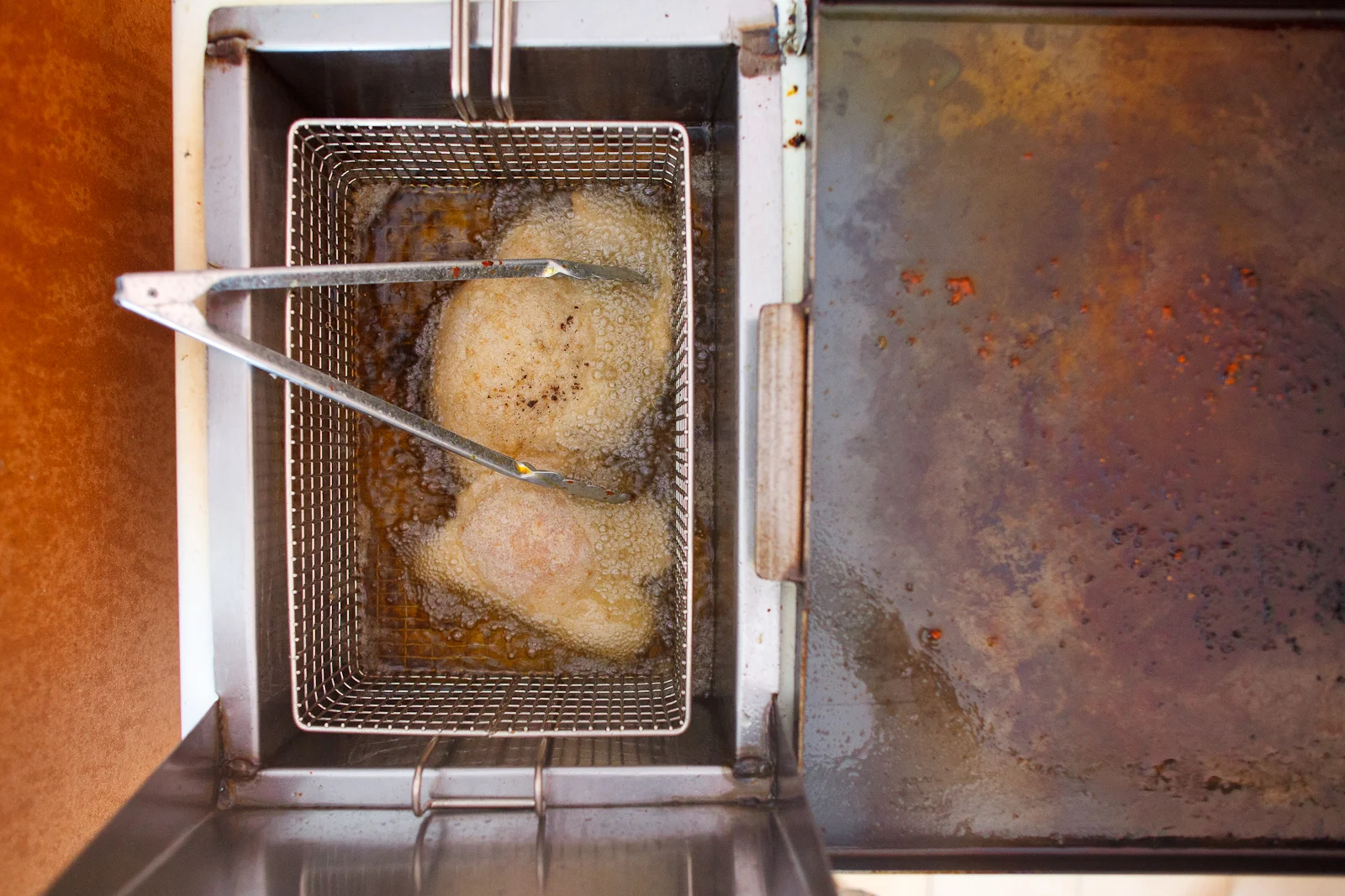 Making the milanesa (deep-fried, breaded pork)