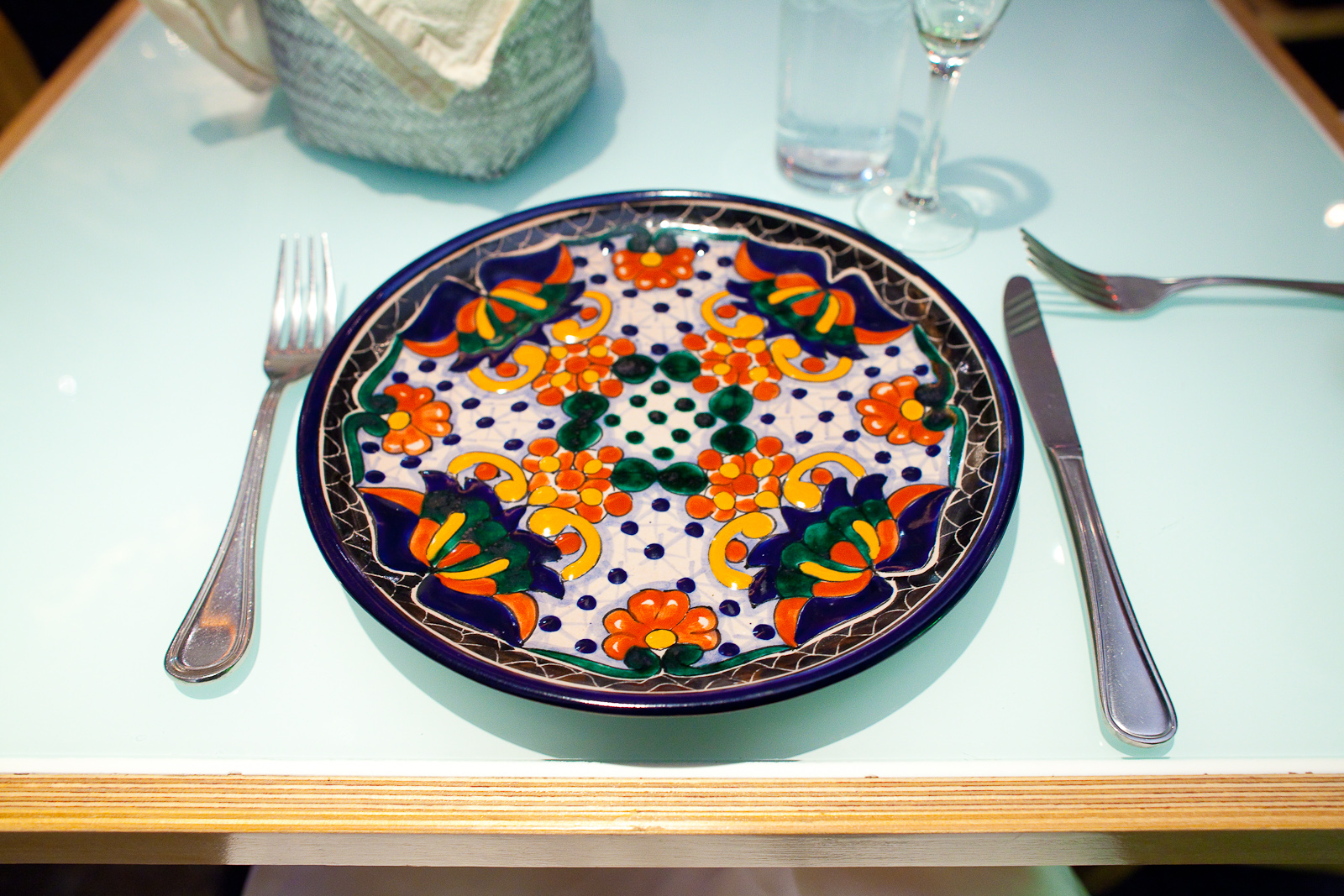 Gorgeous handmade dishware: orange, white, green, and blue plate